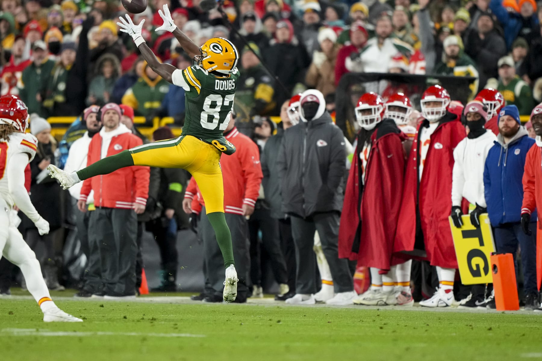 GREEN BAY, WI - DECEMBER 3: Wide receiver Romeo Doubs #87 of the Green Bay Packers jumps up for the ball during an NFL football game against the Kansas City Chiefs at Lambeau Field on December 3, 2023 in Green Bay, Wisconsin. (Photo by Todd Rosenberg/Getty Images)
