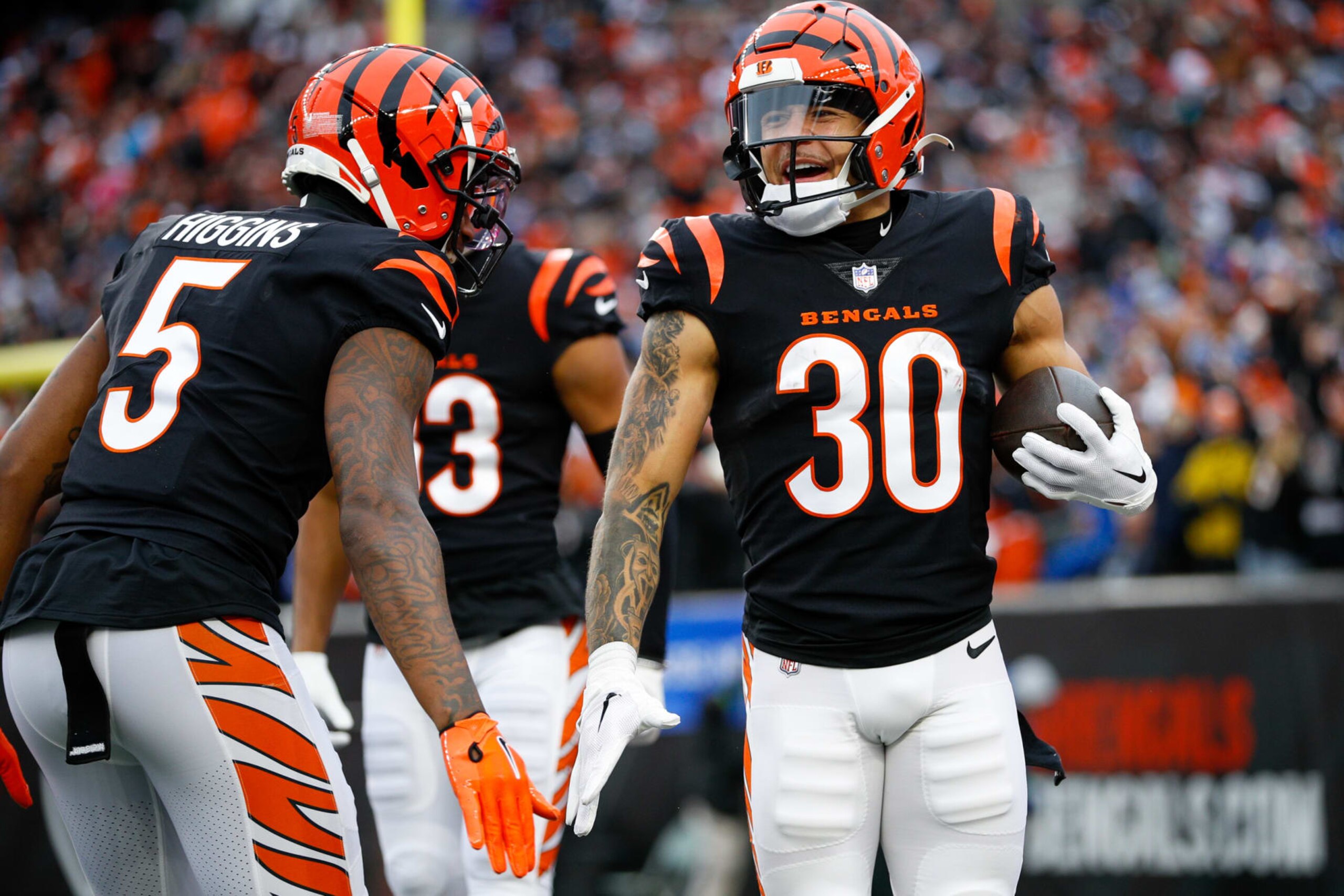 CINCINNATI, OH - DECEMBER 10: Cincinnati Bengals running back Chase Brown (30) reacts with wide receiver Tee Higgins (5) after scoring a touchdown during the game against the Indianapolis Colts and the Cincinnati Bengals on December 10, 2023, at Paycor Stadium in Cincinnati, OH. (Photo by Ian Johnson/Icon Sportswire via Getty Images)
