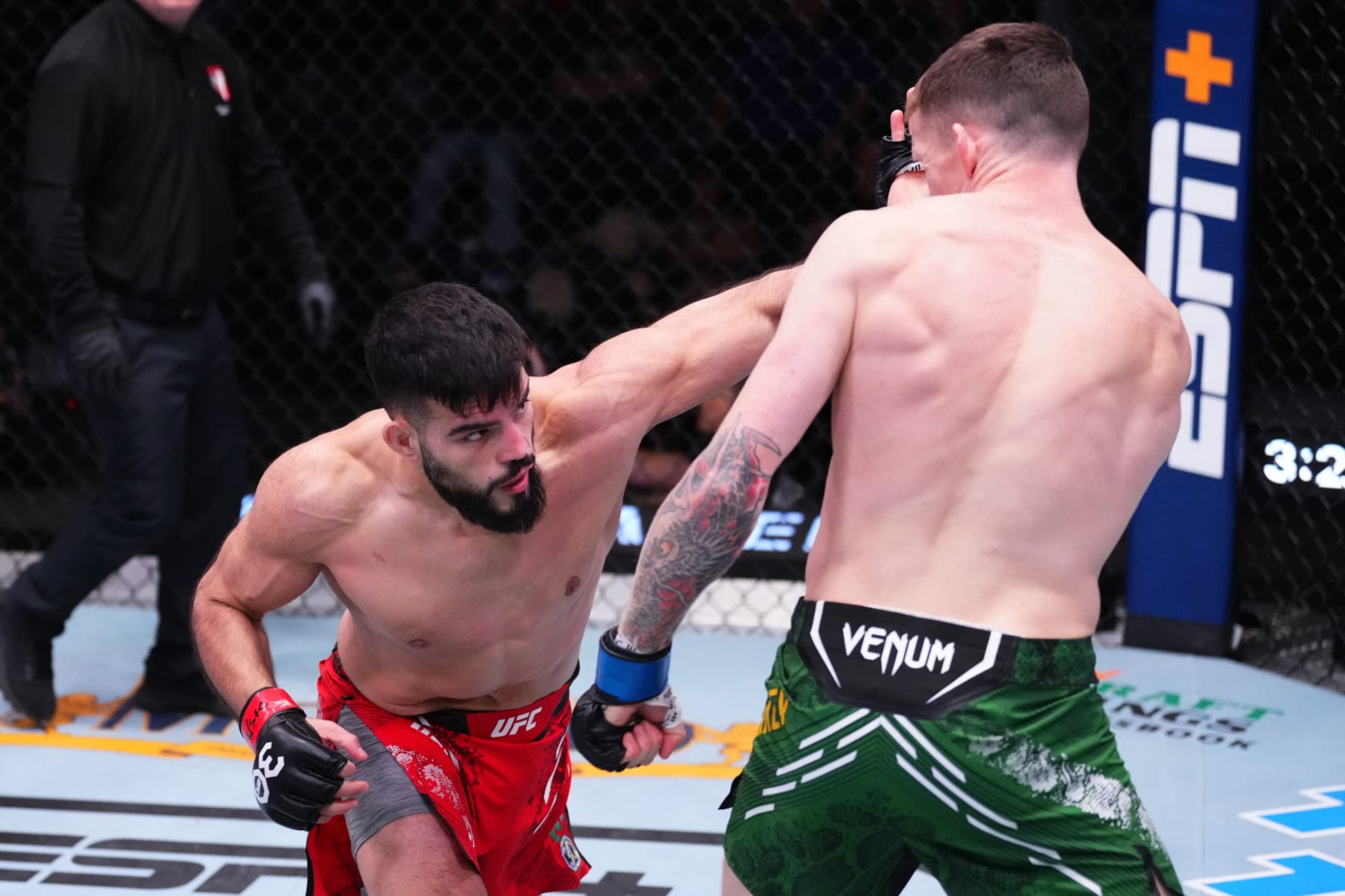 LAS VEGAS, NEVADA - DECEMBER 09: (L-R) Nasrat Haqparast of Germany punches Jamie Mullarkey of Australia in a lightweight fight during the UFC Fight Night event at UFC APEX on December 09, 2023 in Las Vegas, Nevada. (Photo by Jeff Bottari/Zuffa LLC via Getty Images)