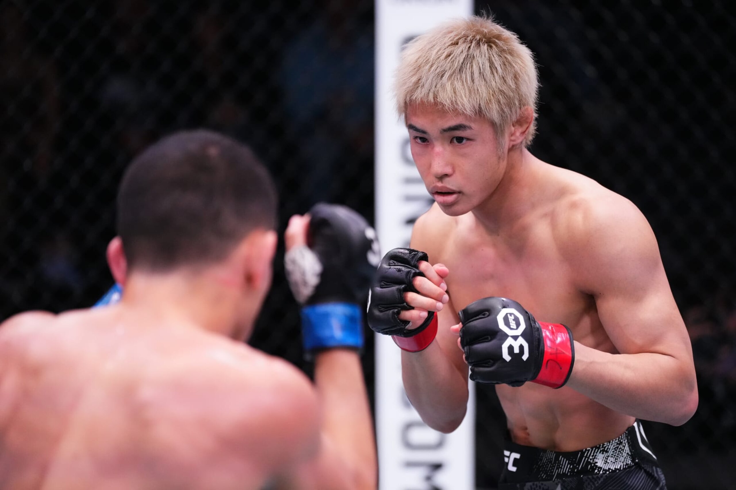 LAS VEGAS, NEVADA - DECEMBER 09: (R-L) Tatsuro Taira of Japan battles Carlos Hernandez in a flyweight fight during the UFC Fight Night event at UFC APEX on December 09, 2023 in Las Vegas, Nevada. (Photo by Jeff Bottari/Zuffa LLC via Getty Images)