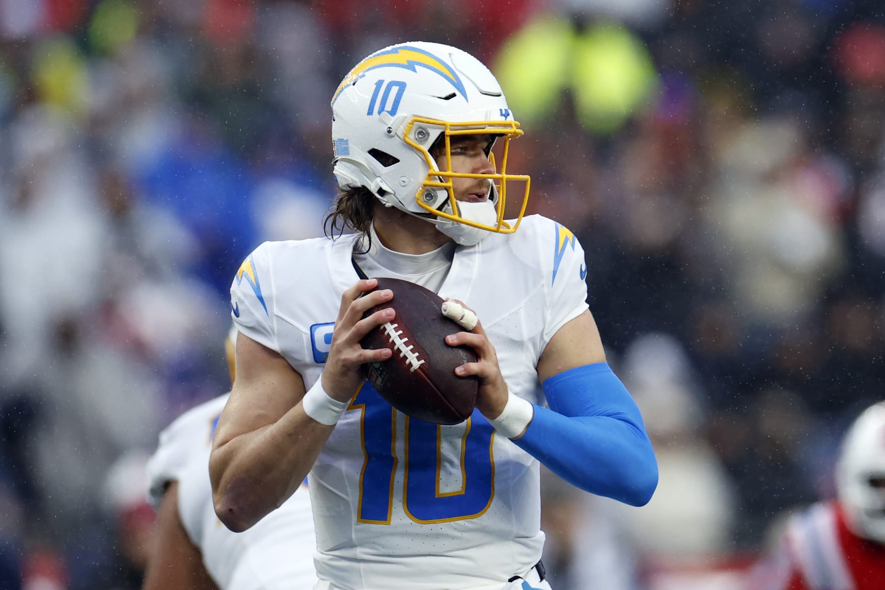 Foxborough, MA - December 3: Los Angeles Chargers QB Justin Herbert seeks out a receiver in the first half. The Chargers beat the New England Patriots, 6-0. (Photo by Danielle Parhizkaran/The Boston Globe via Getty Images)