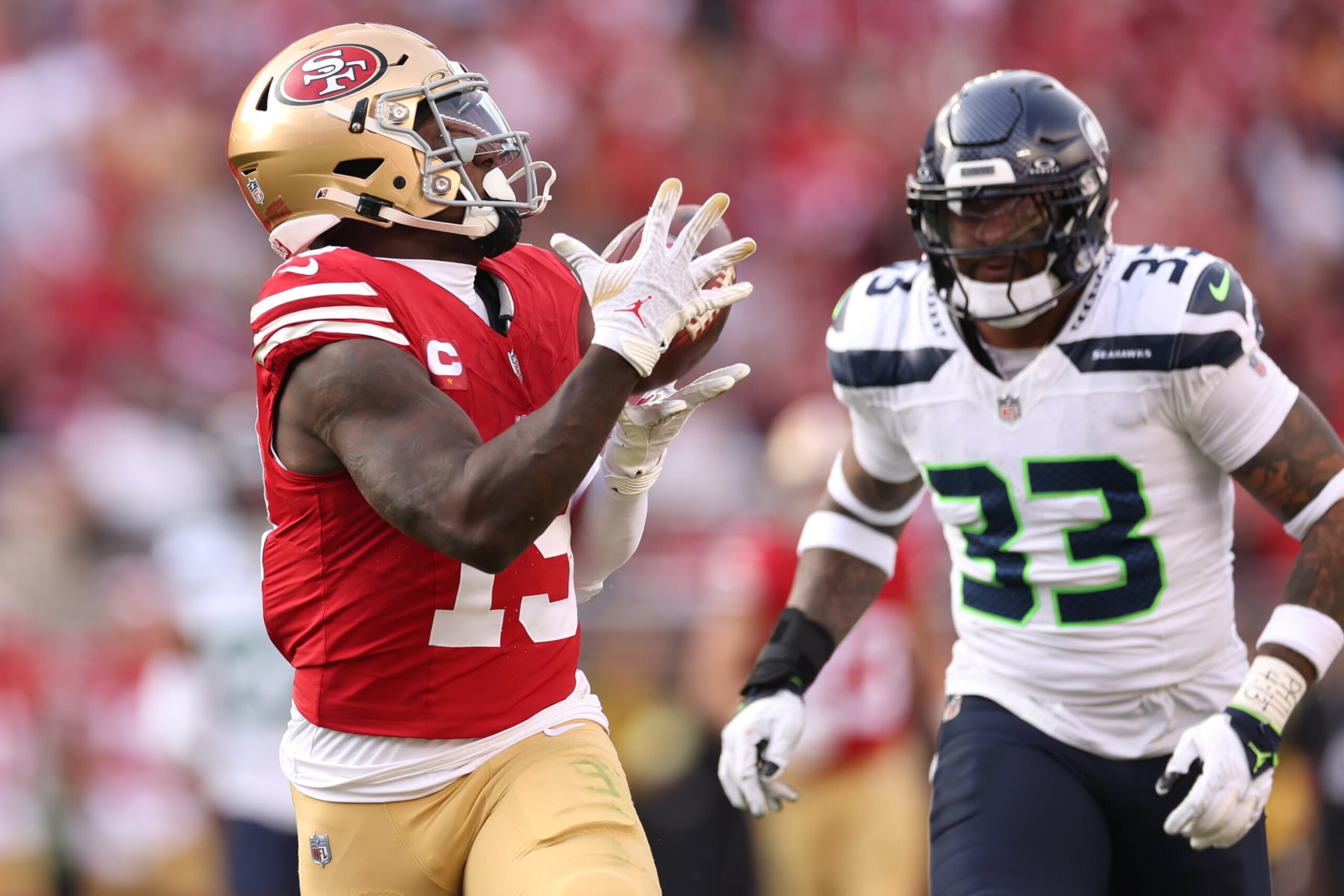 SANTA CLARA, CALIFORNIA - DECEMBER 10: Deebo Samuel #19 of the San Francisco 49ers catches a pass for a touchdown over Jamal Adams #33 of the Seattle Seahawks during the second quarter at Levi's Stadium on December 10, 2023 in Santa Clara, California. (Photo by Ezra Shaw/Getty Images)