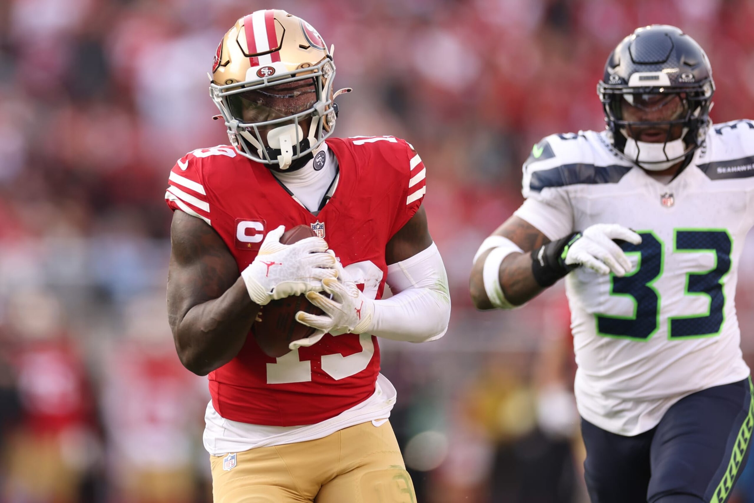 SANTA CLARA, CALIFORNIA - DECEMBER 10: Deebo Samuel #19 of the San Francisco 49ers catches a pass for a touchdown over Jamal Adams #33 of the Seattle Seahawks during the second quarter at Levi's Stadium on December 10, 2023 in Santa Clara, California. (Photo by Ezra Shaw/Getty Images) SANTA CLARA, CALIFORNIA - DECEMBER 10: Deebo Samuel #19 of the San Francisco 49ers catches a pass for a touchdown over Jamal Adams #33 of the Seattle Seahawks during the second quarter at Levi's Stadium on December 10, 2023 in Santa Clara, California. (Photo by Ezra Shaw/Getty Images)