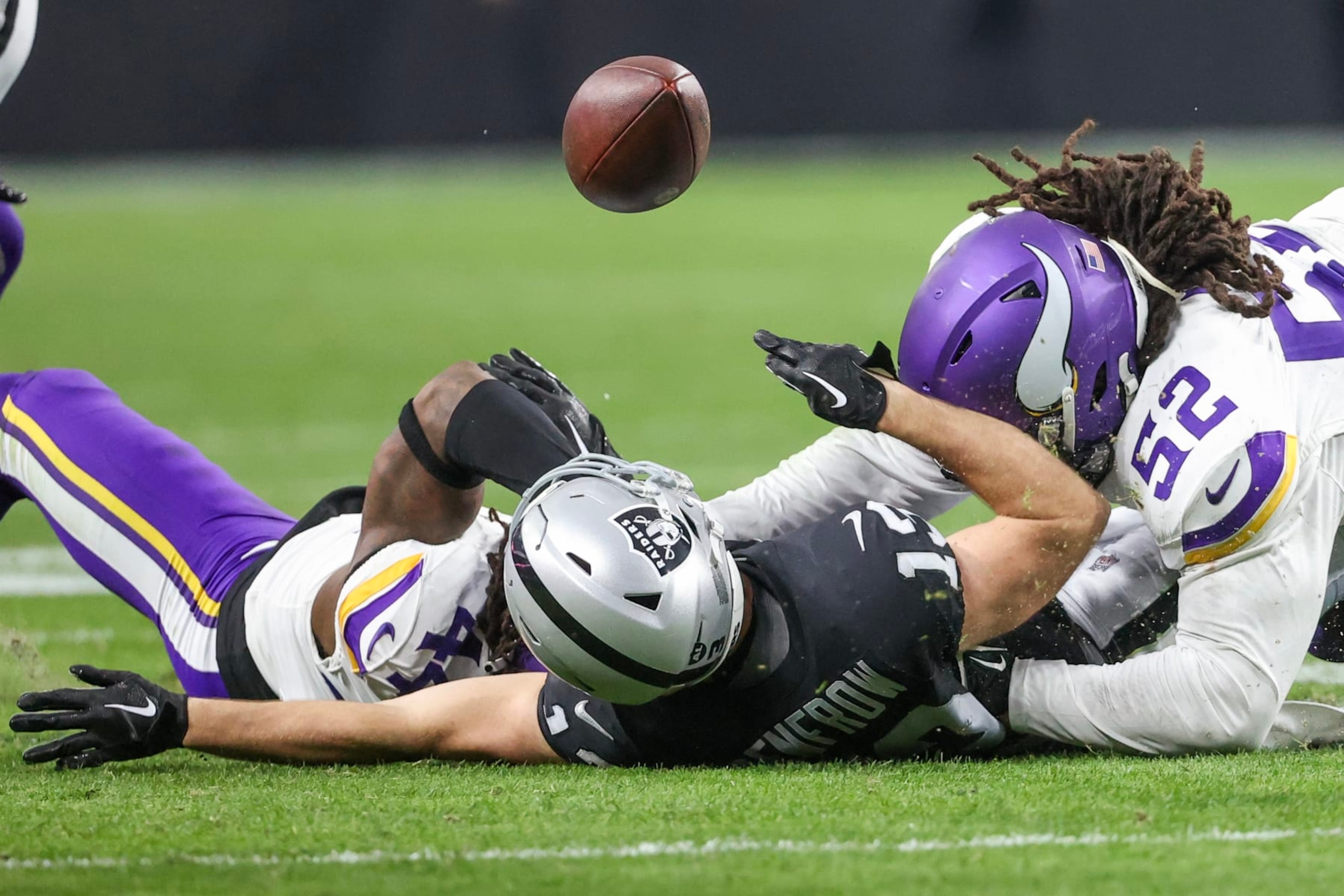 LAS VEGAS, NEVADA - DECEMBER 10: Hunter Renfrow #13 of the Las Vegas Raiders fumbles the ball as he is tackled by 
Josh Metellus #44 of the Minnesota Vikings during the first half of the game at Allegiant Stadium on December 10, 2023 in Las Vegas, Nevada. (Photo by Ian Maule/Getty Images)