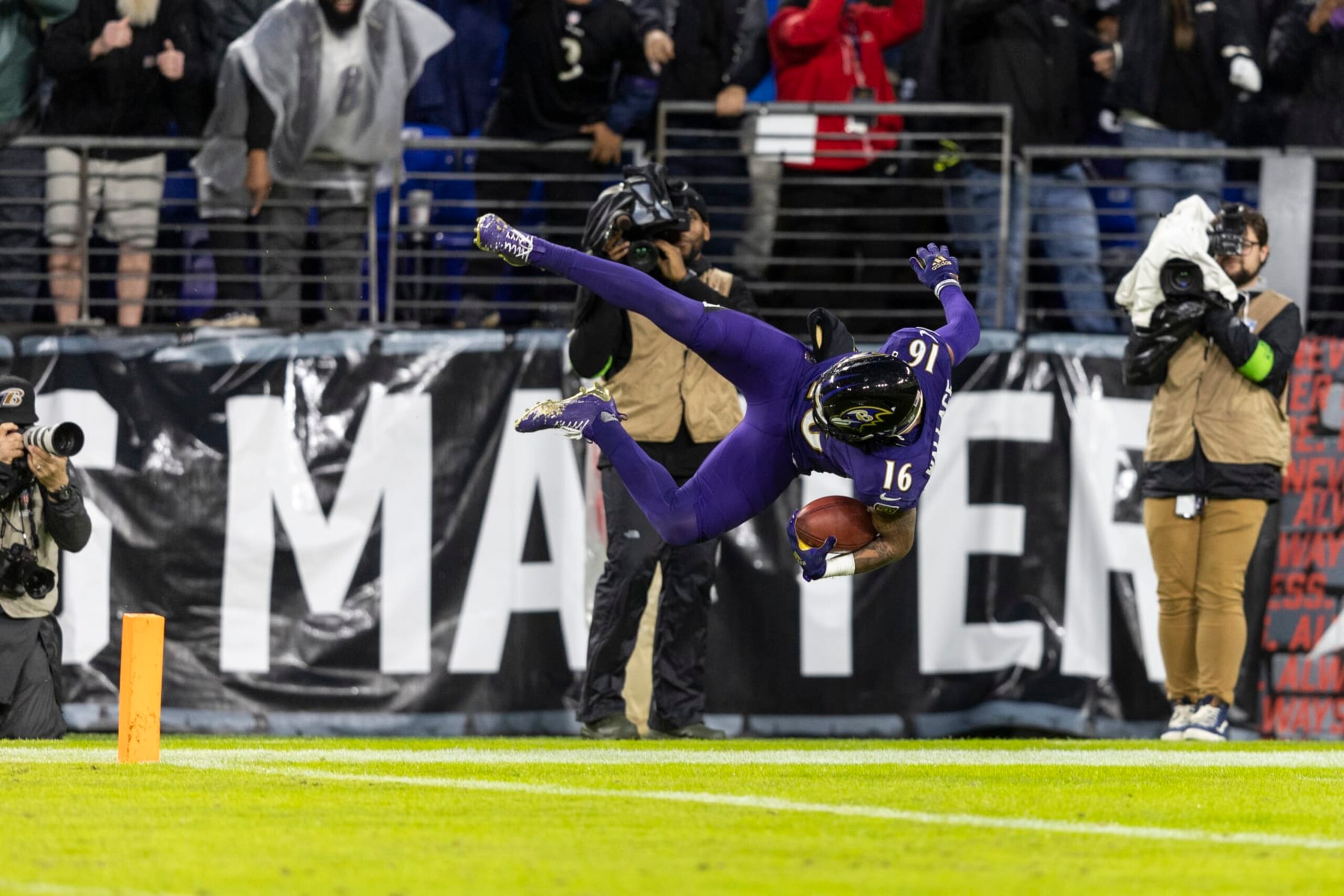 BALTIMORE, MARYLAND - DECEMBER 10: Tylan Wallace #16 of the Baltimore Ravens dives into the end zone as he returns a punt for a  touchdown in overtime during an NFL football game between the Baltimore Ravens and the Los Angeles Rams at M&T Bank Stadium on December 10, 2023 in Baltimore, Maryland. (Photo by Michael Owens/Getty Images)