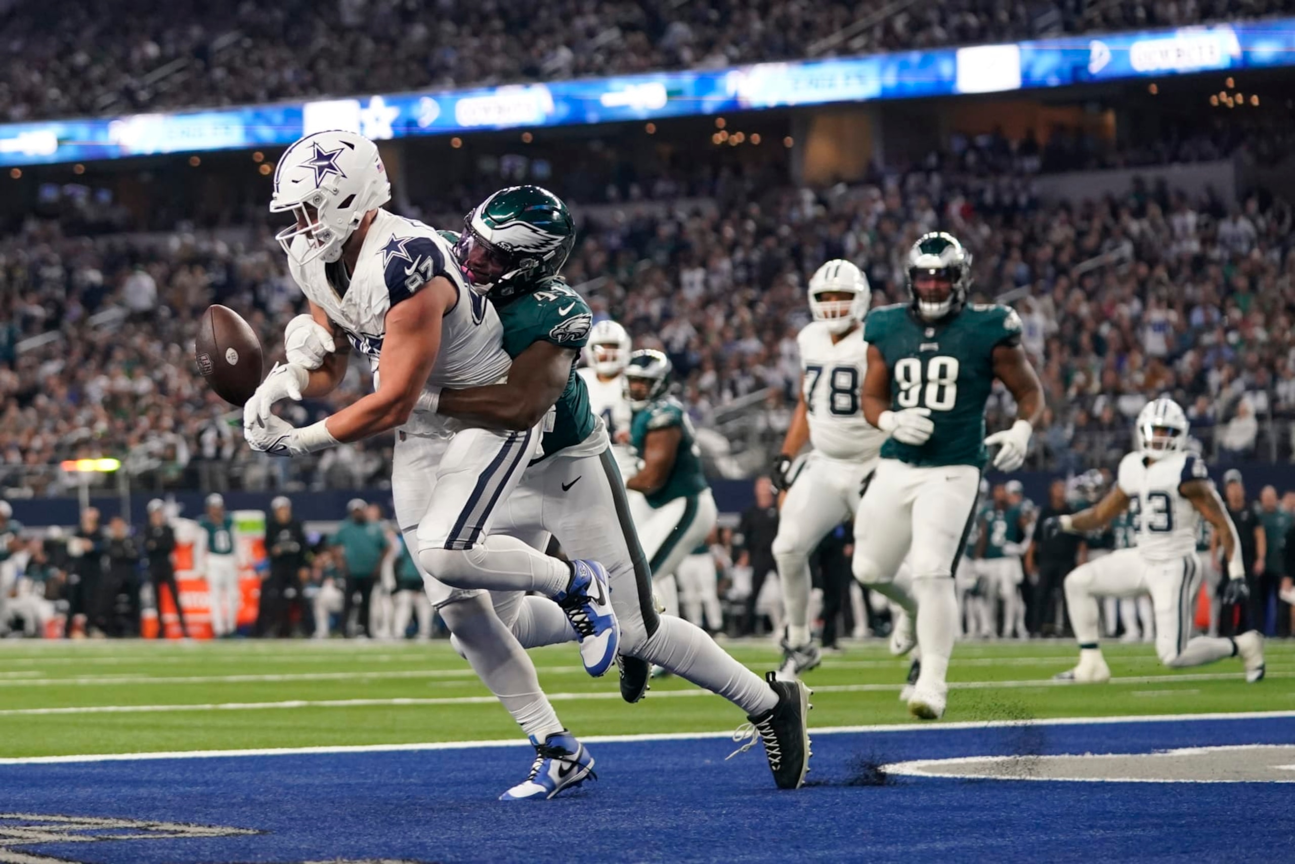 Philadelphia Eagles linebacker Nicholas Morrow, right, breaks up a pass intended for Dallas Cowboys tight end Jake Ferguson (87) during the first half of an NFL football game, Sunday, Dec. 10, 2023, in Arlington, Texas. (AP Photo/Sam Hodde)