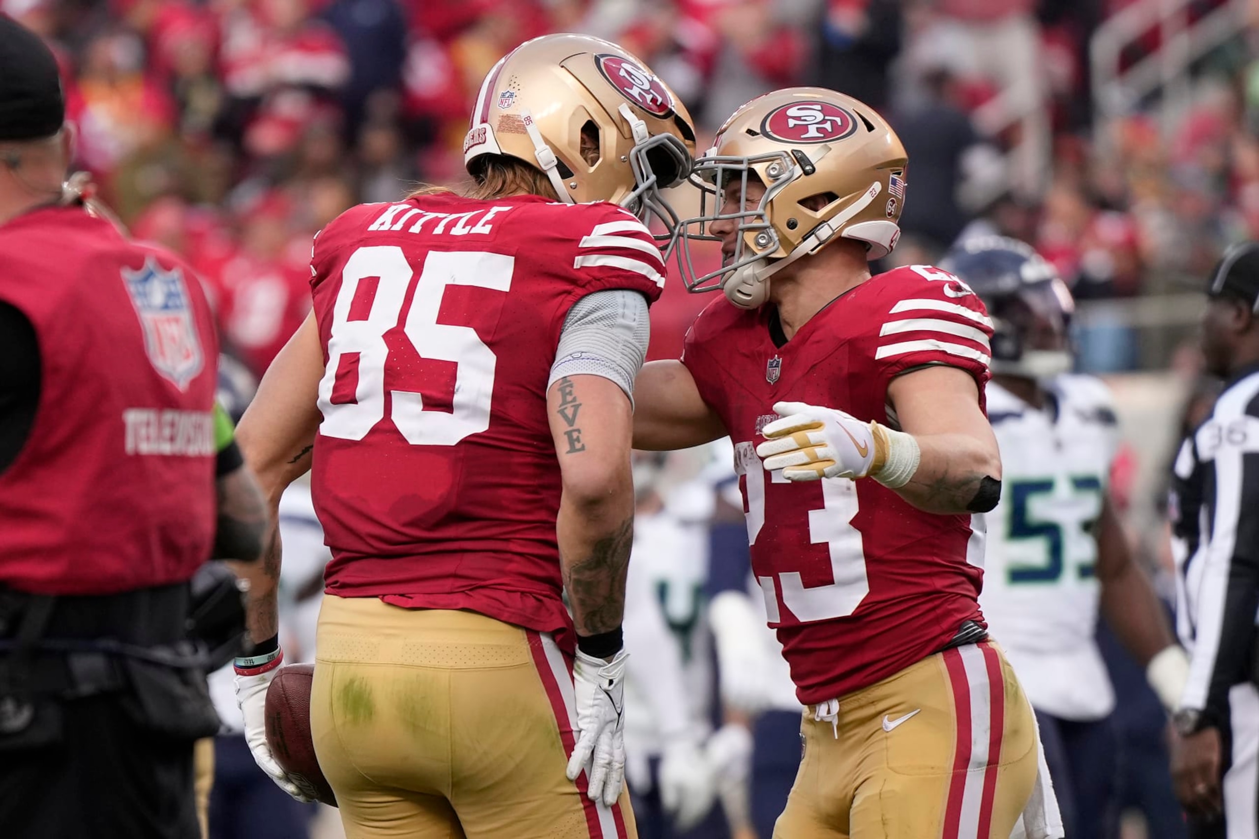 SANTA CLARA, CALIFORNIA - DECEMBER 10: George Kittle #85 of the San Francisco 49ers celebrates after a touchdown with Christian McCaffrey #23 of the San Francisco 49ers during the fourth quarter in the game against the Seattle Seahawks at Levi's Stadium on December 10, 2023 in Santa Clara, California. (Photo by Thearon W. Henderson/Getty Images)