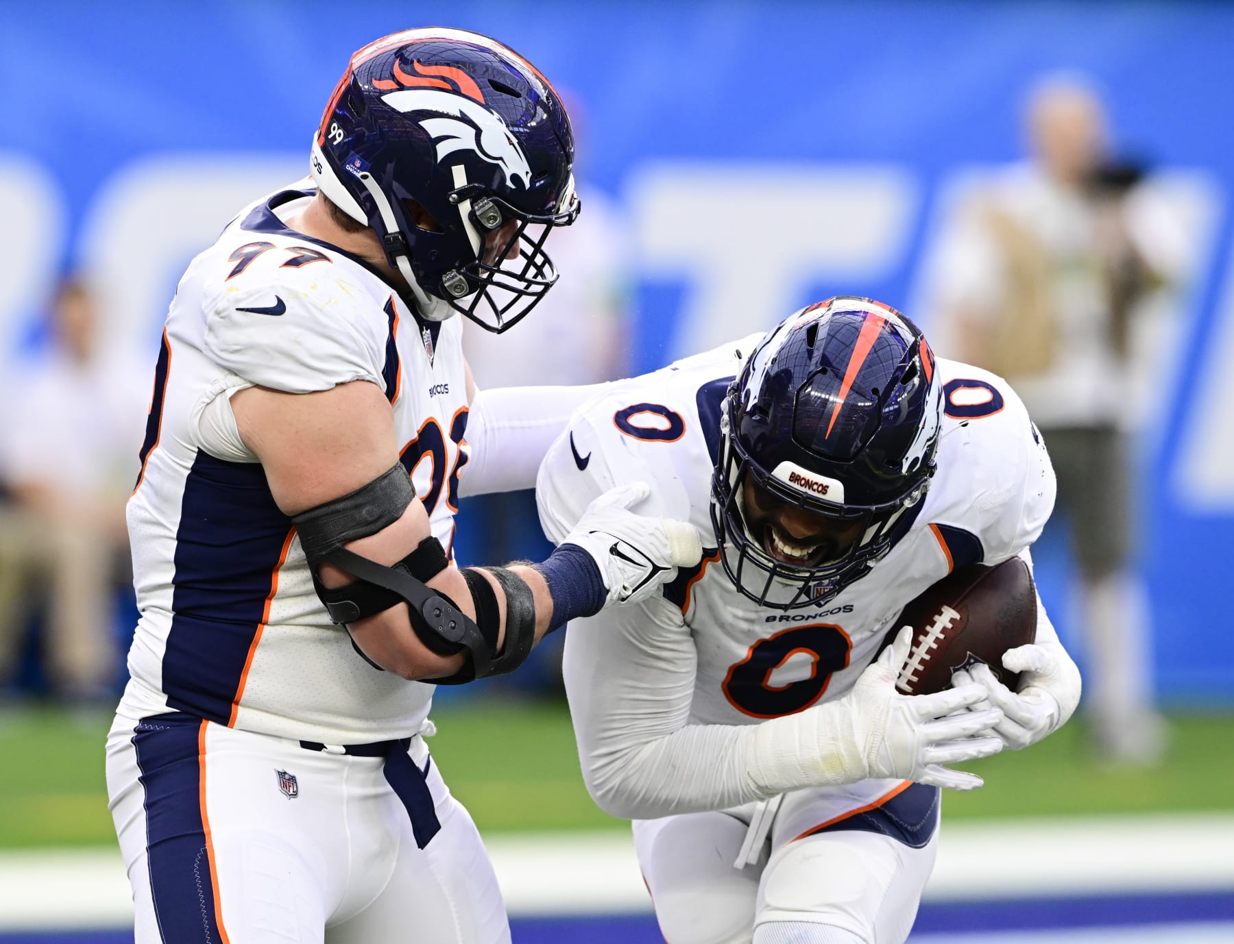 INGLEWOOD, CA - DECEMBER 10: Denver Broncos linebacker Jonathon Cooper (0) celebrates his interception from Los Angeles Chargers quarterback Justin Herbert (10) with teammate Zach Allen (99) in the first quarter at SoFi Stadium in Inglewood, California Sunday December 10, 2023. (Photo by Andy Cross/MediaNews Group/The Denver Post via Getty Images)