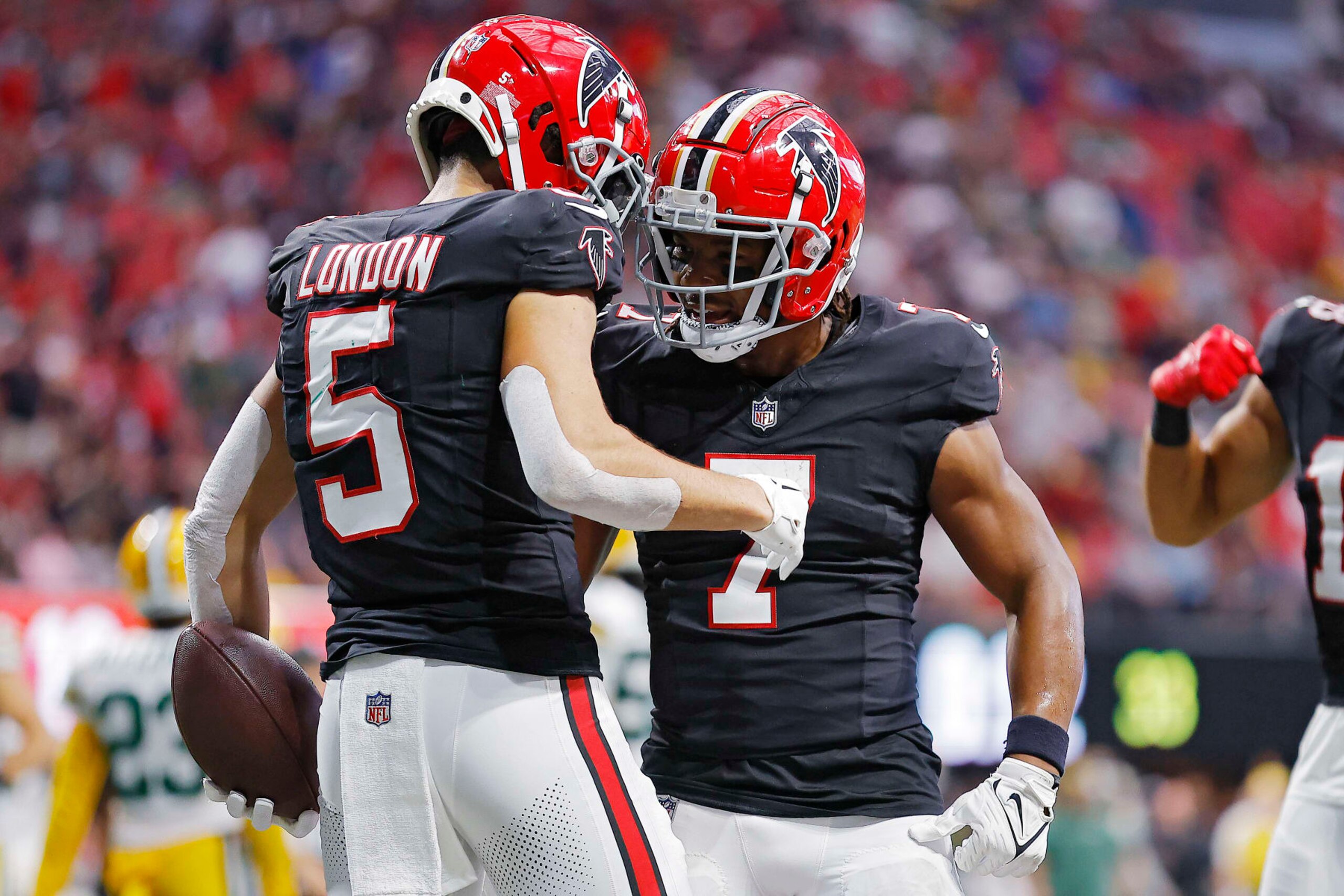 ATLANTA, GEORGIA - SEPTEMBER 17: Drake London #5 of the Atlanta Falcons and Bijan Robinson #7 celebrate a touchdown  during the second quarter in the game against the Green Bay Packers at Mercedes-Benz Stadium on September 17, 2023 in Atlanta, Georgia. (Photo by Todd Kirkland/Getty Images)