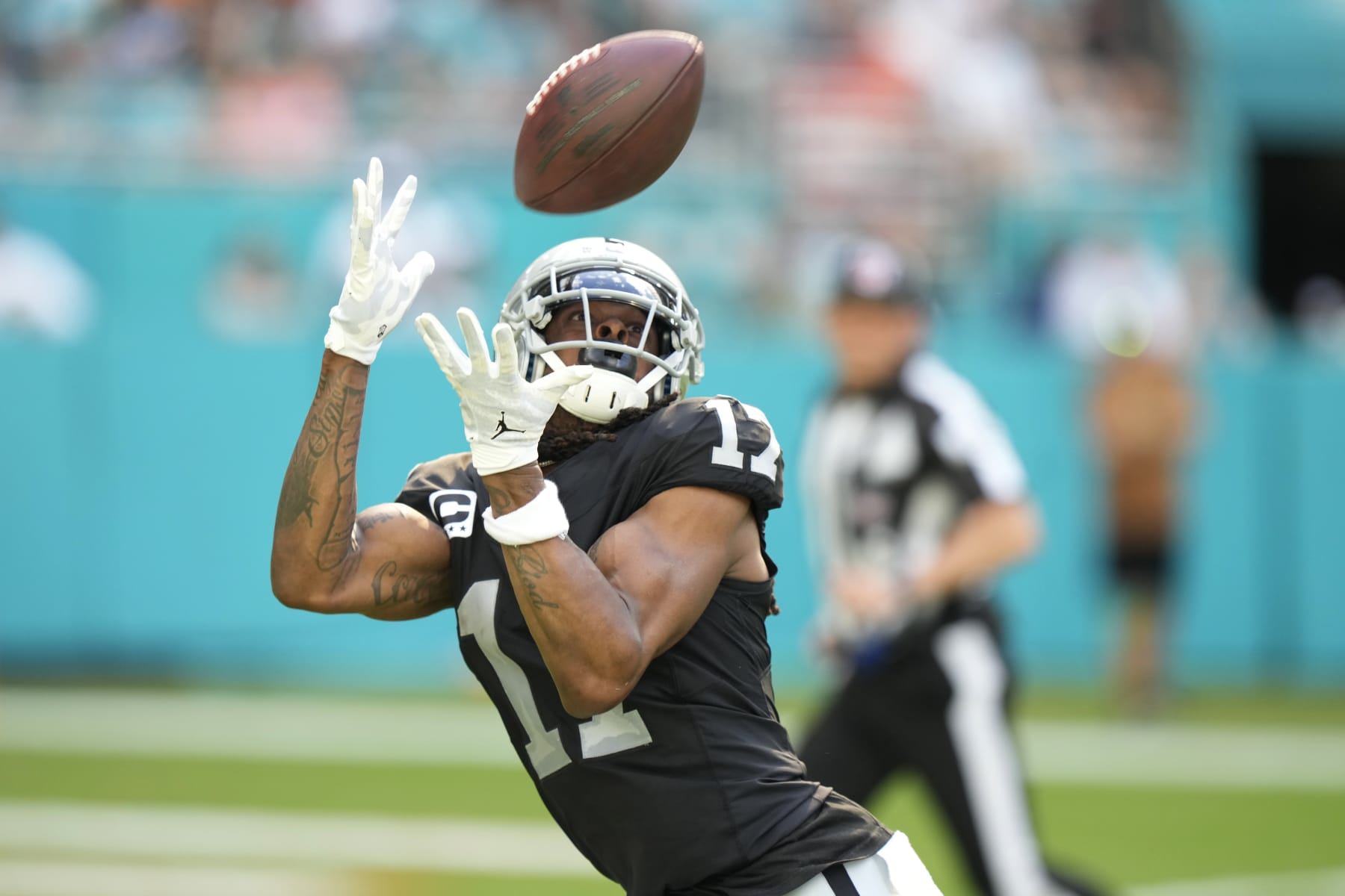 Las Vegas Raiders wide receiver Davante Adams (17) catches a touchdown pass during the first half of an NFL football game against the Miami Dolphins, Sunday, Nov. 19, 2023, in Miami Gardens, Fla. (AP Photo/Wilfredo Lee)