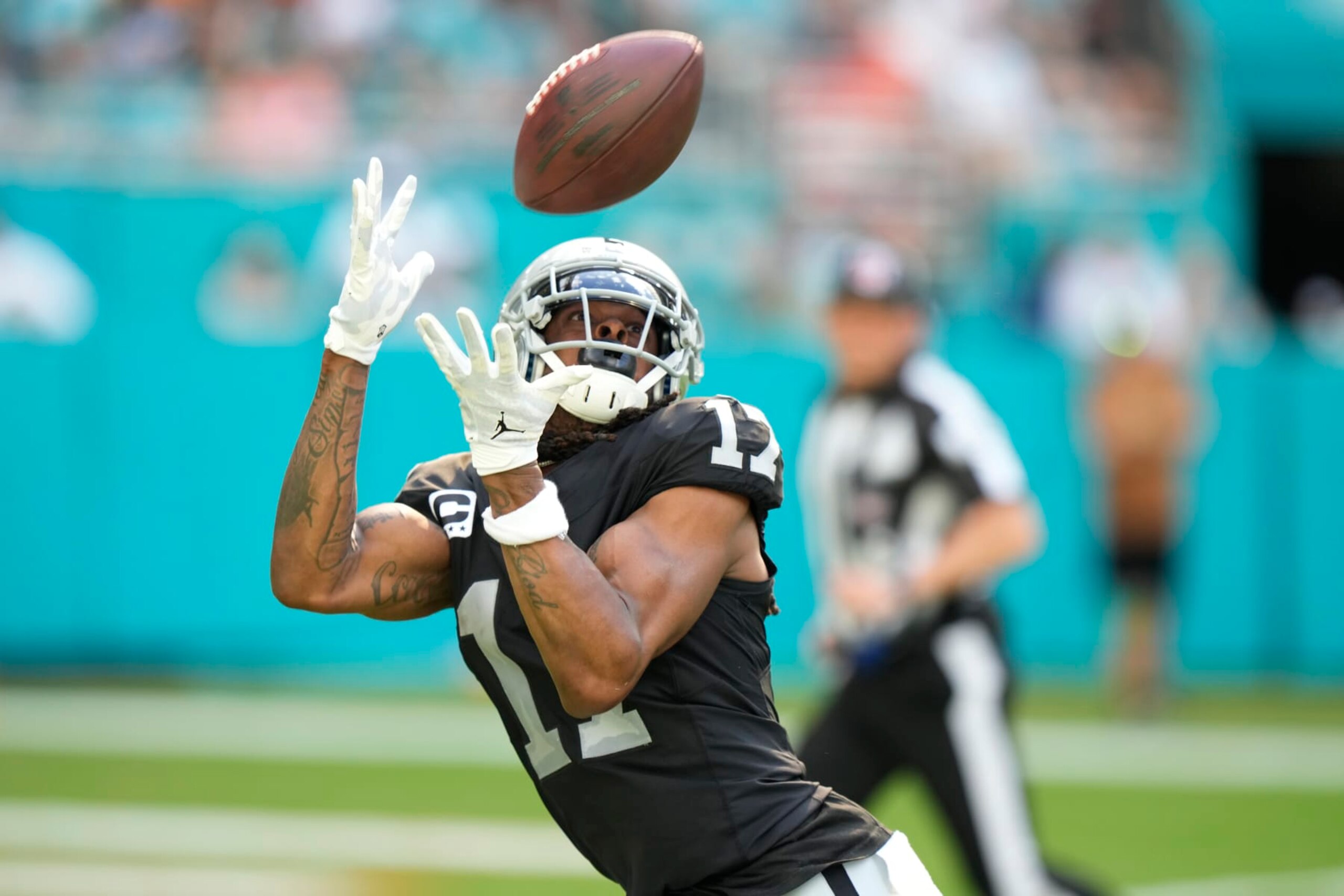 Las Vegas Raiders wide receiver Davante Adams (17) catches a touchdown pass during the first half of an NFL football game against the Miami Dolphins, Sunday, Nov. 19, 2023, in Miami Gardens, Fla. (AP Photo/Wilfredo Lee)