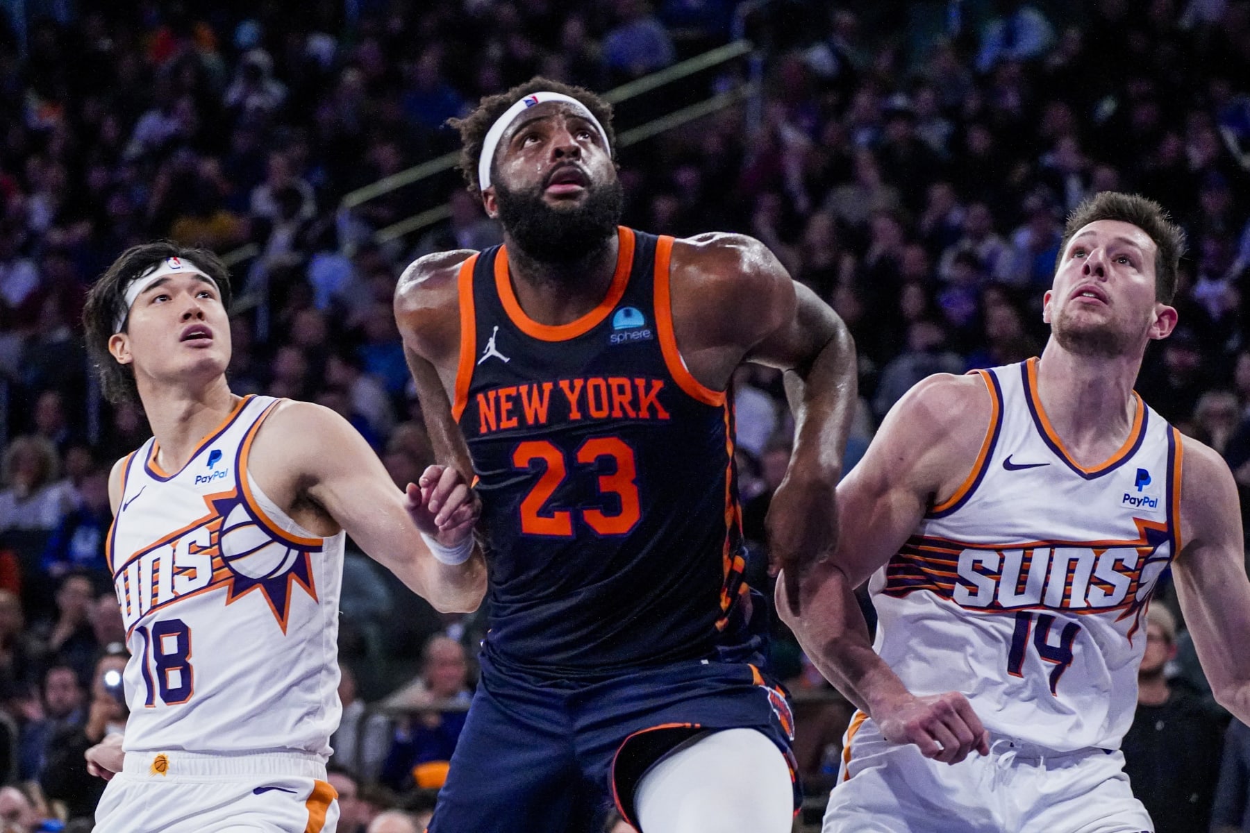 New York Knicks center Mitchell Robinson (23) fights for rebounding position against Phoenix Suns forwards Yuta Watanabe (18) and Drew Eubanks (14) during the second half of an NBA basketball game in New York, Sunday, Nov. 26, 2023. (AP Photo/Peter K. Afriyie)
