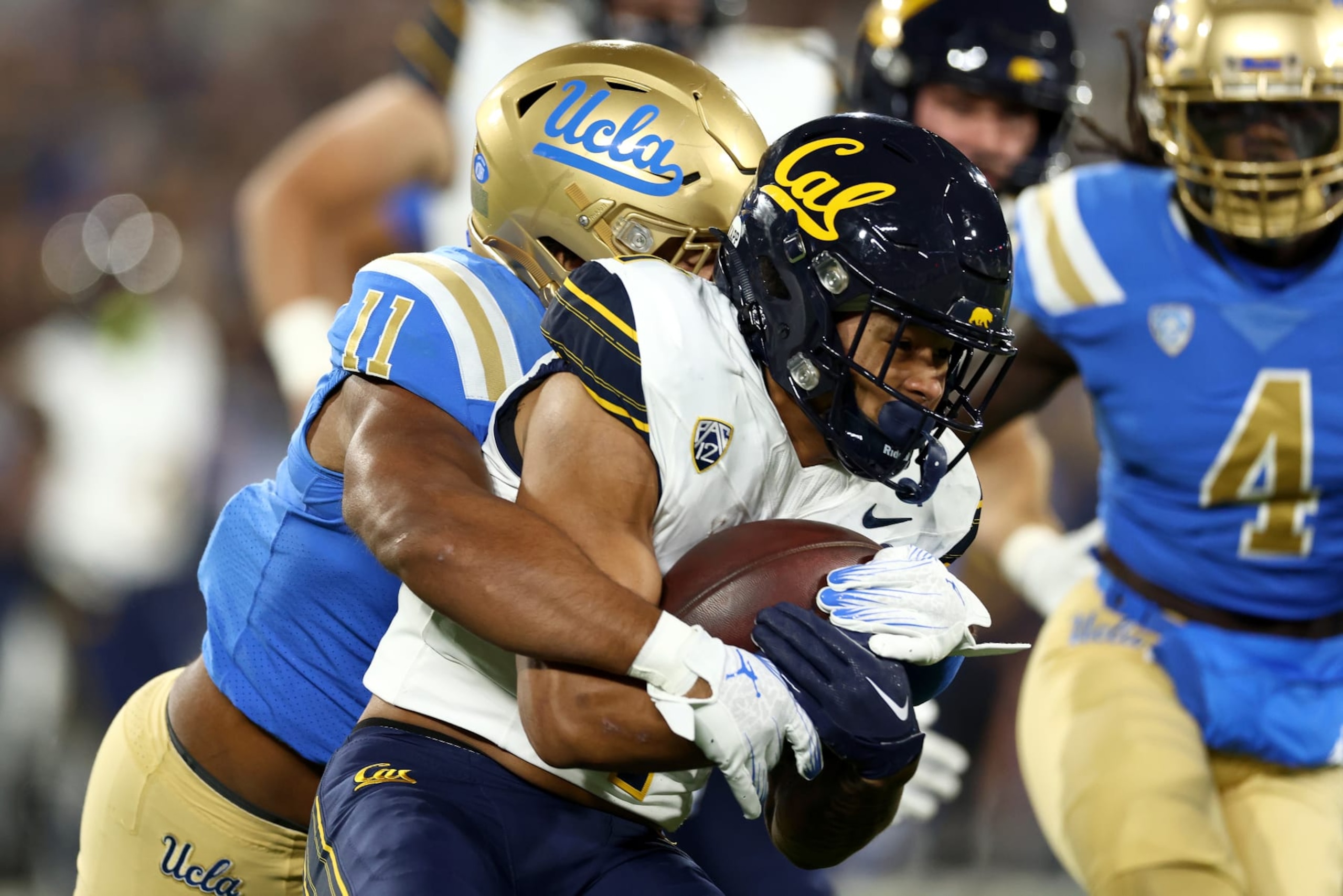 PASADENA, CALIFORNIA - NOVEMBER 25: Gabriel Murphy #11 of the UCLA Bruins tackles Jaydn Ott #1 of the California Golden Bears during the first quarter at Rose Bowl Stadium on November 25, 2023 in Pasadena, California. (Photo by Katelyn Mulcahy/Getty Images) PASADENA, CALIFORNIA - NOVEMBER 25: Gabriel Murphy #11 of the UCLA Bruins tackles Jaydn Ott #1 of the California Golden Bears during the first quarter at Rose Bowl Stadium on November 25, 2023 in Pasadena, California. (Photo by Katelyn Mulcahy/Getty Images)