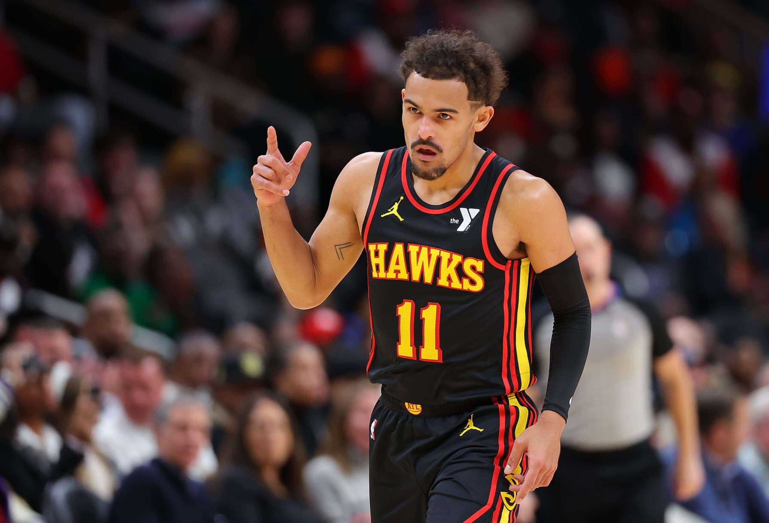 ATLANTA, GEORGIA - DECEMBER 11:  Trae Young #11 of the Atlanta Hawks reacts after hitting a three-point basket against the Denver Nuggets during the first quarter at State Farm Arena on December 11, 2023 in Atlanta, Georgia.  NOTE TO USER: User expressly acknowledges and agrees that, by downloading and/or using this photograph, user is consenting to the terms and conditions of the Getty Images License Agreement.  (Photo by Kevin C. Cox/Getty Images)