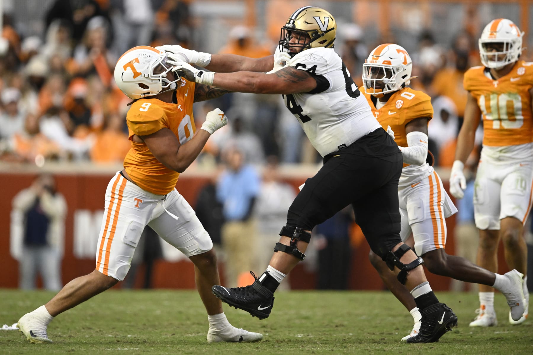 KNOXVILLE, TENNESSEE - NOVEMBER 25: Tyler Baron #9 of the Tennessee Volunteers and Delfin Xavier Castillo #64 of the Vanderbilt Commodores get in a scuffle in the second quarter at Neyland Stadium on November 25, 2023 in Knoxville, Tennessee. (Photo by Eakin Howard/Getty Images)