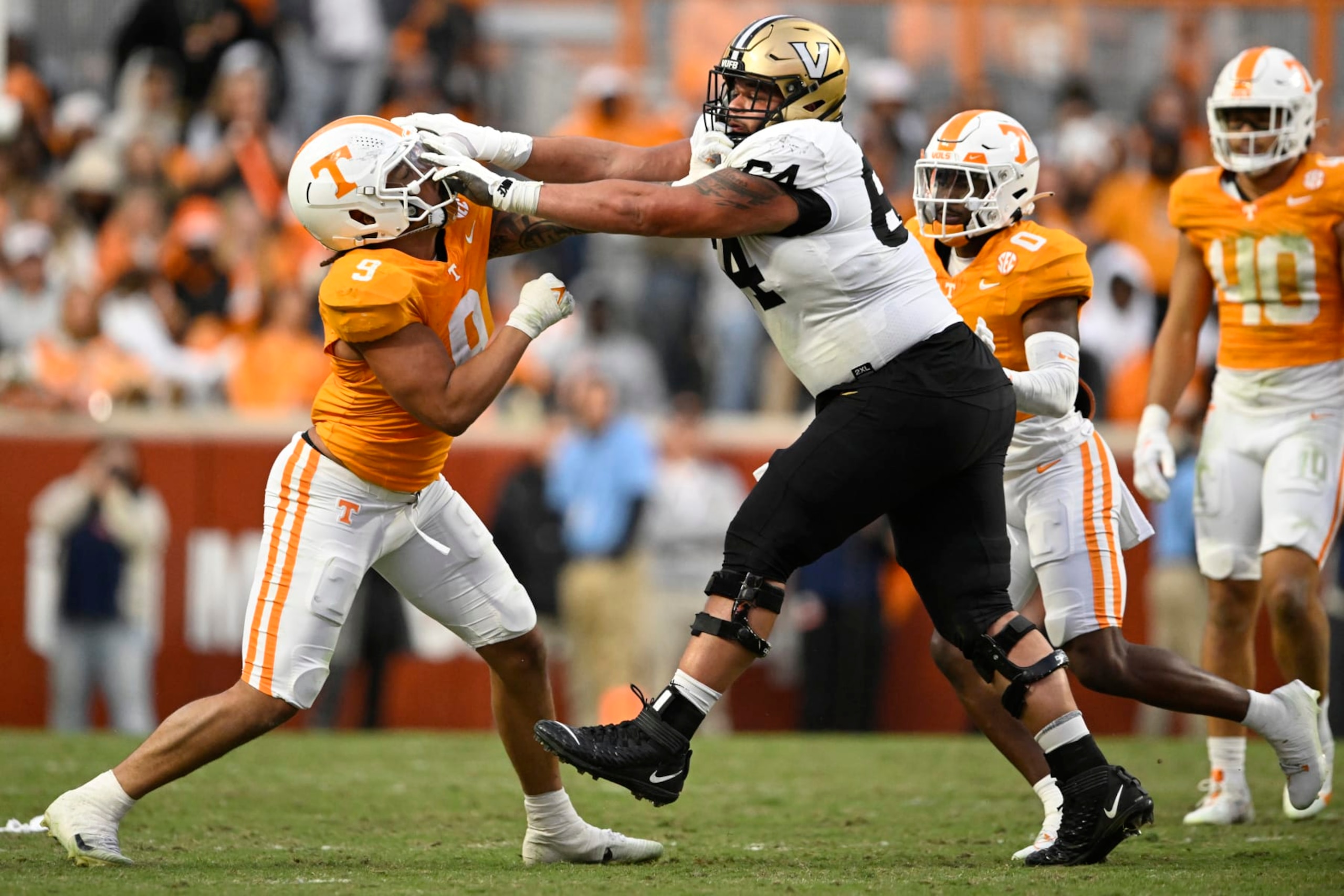 KNOXVILLE, TENNESSEE - NOVEMBER 25: Tyler Baron #9 of the Tennessee Volunteers and Delfin Xavier Castillo #64 of the Vanderbilt Commodores get in a scuffle in the second quarter at Neyland Stadium on November 25, 2023 in Knoxville, Tennessee. (Photo by Eakin Howard/Getty Images)