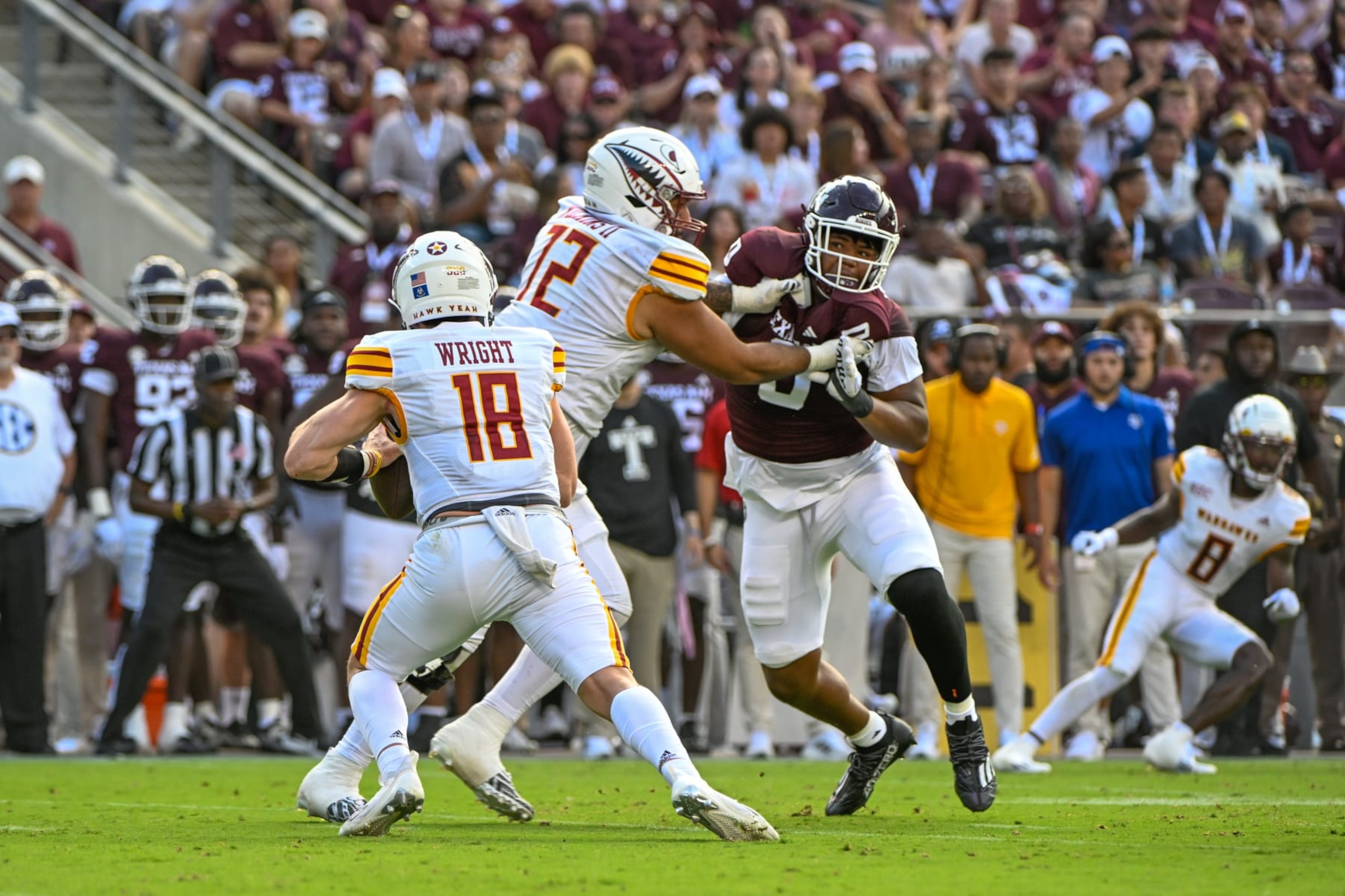 COLLEGE STATION, TX - SEPTEMBER 16: Louisiana Monroe Warhawks quarterback Jiya Wright (18) is flushed from the pocket as Texas A&M Aggies defensive lineman Walter Nolen (0) provides pressure during the football game between the Louisiana Monroe Warhawks and Texas A&M Aggies at Kyle Field on September 16, 2023 in College Station, Texas. (Photo by Ken Murray/Icon Sportswire via Getty Images)