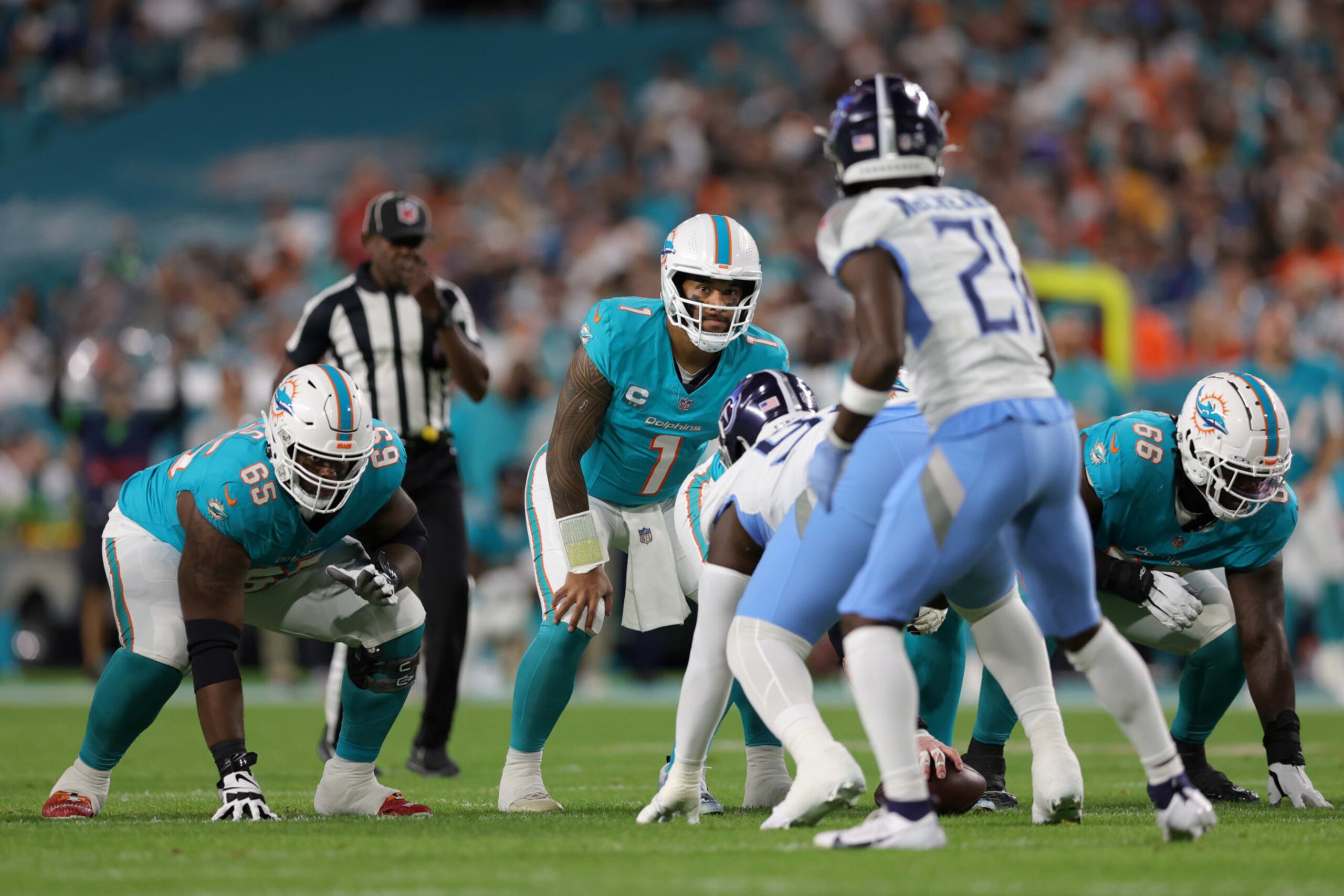 MIAMI GARDENS, FLORIDA - DECEMBER 11: Tua Tagovailoa #1 of the Miami Dolphins under center in the first half against the Tennessee Titans at Hard Rock Stadium on December 11, 2023 in Miami Gardens, Florida. (Photo by Megan Briggs/Getty Images)
