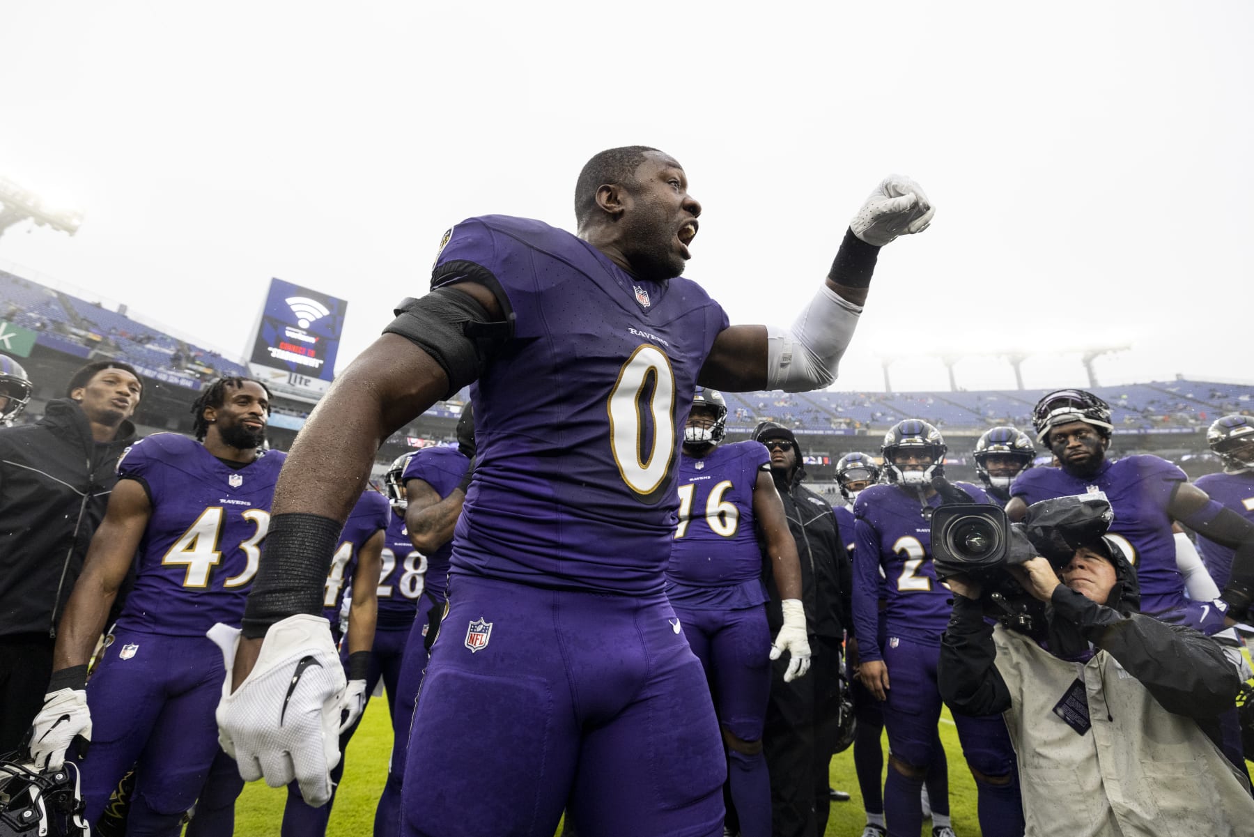 BALTIMORE, MARYLAND - DECEMBER 10: Roquan Smith #0 of the Baltimore Ravens reacts as he looks on during a huddle prior to an NFL football game between the Baltimore Ravens and the Los Angeles Rams at M&T Bank Stadium on December 10, 2023 in Baltimore, Maryland. (Photo by Michael Owens/Getty Images)