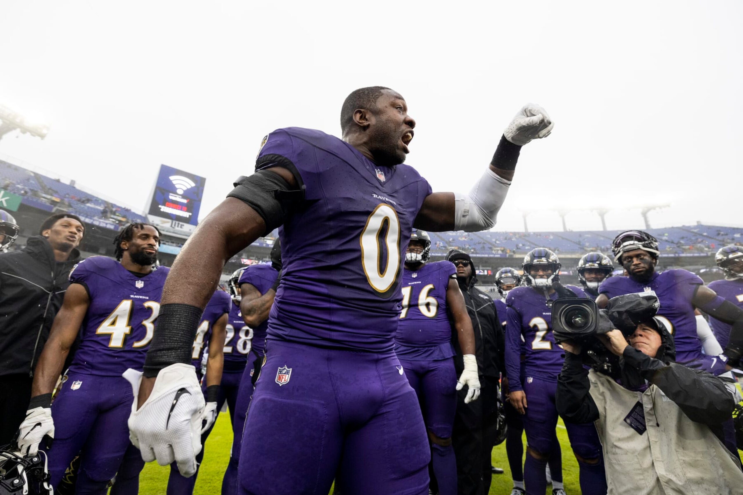 BALTIMORE, MARYLAND - DECEMBER 10: Roquan Smith #0 of the Baltimore Ravens reacts as he looks on during a huddle prior to an NFL football game between the Baltimore Ravens and the Los Angeles Rams at M&T Bank Stadium on December 10, 2023 in Baltimore, Maryland. (Photo by Michael Owens/Getty Images)