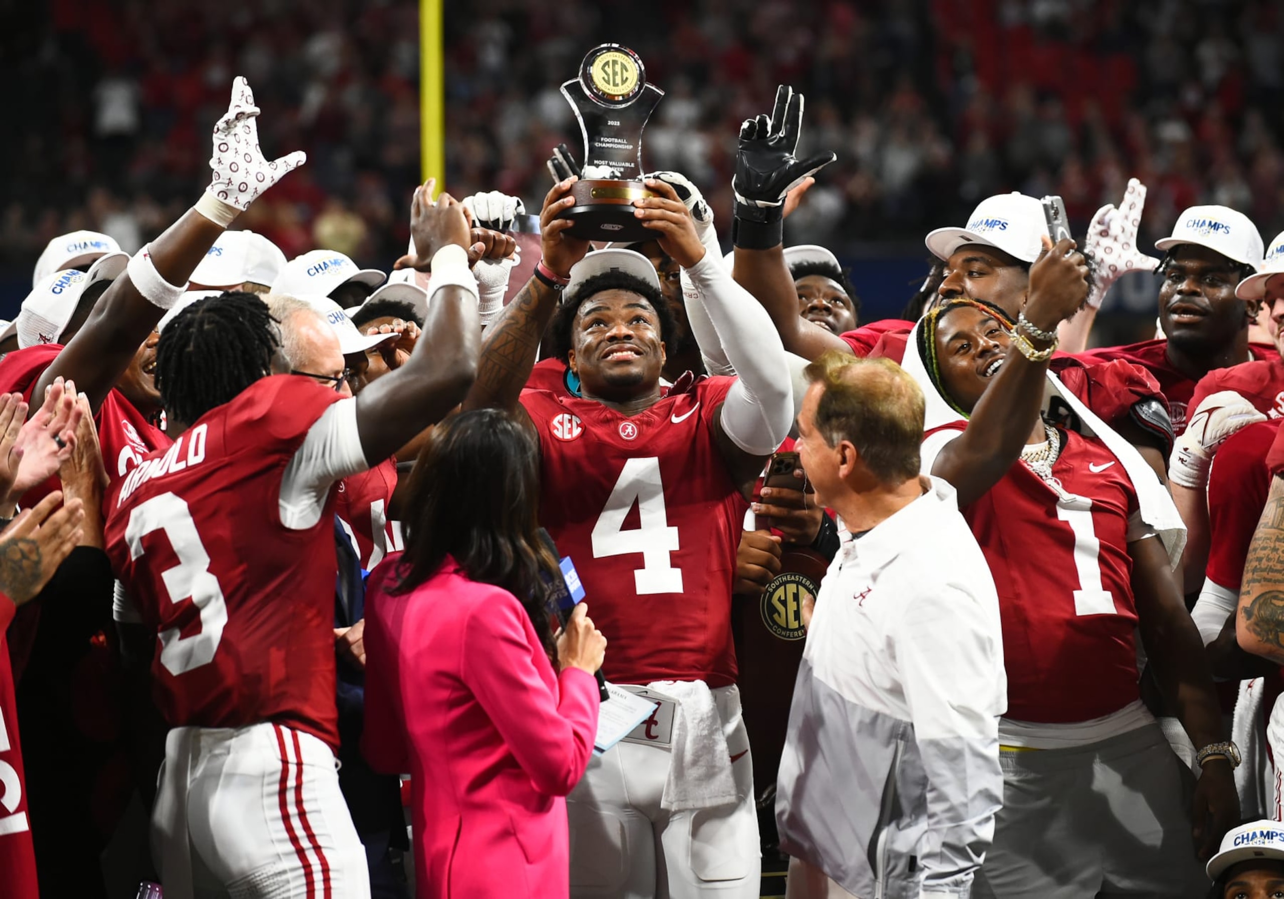 ATLANTA, GA - DECEMBER 02: Alabama Crimson Tide Quarterback Jalen Milroe (4) holds up the player of the game trophy after the SEC Championship Game between the Georgia Bulldogs and the Alabama Crimson Tide on December 02, 2023, at Mercedes-Benz Stadium in Atlanta, GA. (Photo by Jeffrey Vest/Icon Sportswire via Getty Images)