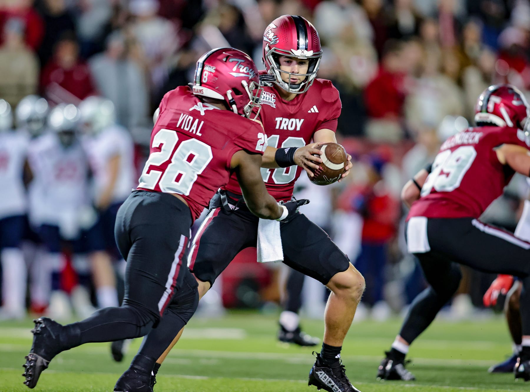 TROY, ALABAMA - NOVEMBER 2: Gunnar Watson #18 hands the ball off to Kimani Vidal #28 of the Troy Trojans during the first half at Veterans Memorial Stadium on November 2, 2023 in Troy, Alabama. (Photo by Brandon Sumrall/Getty Images)