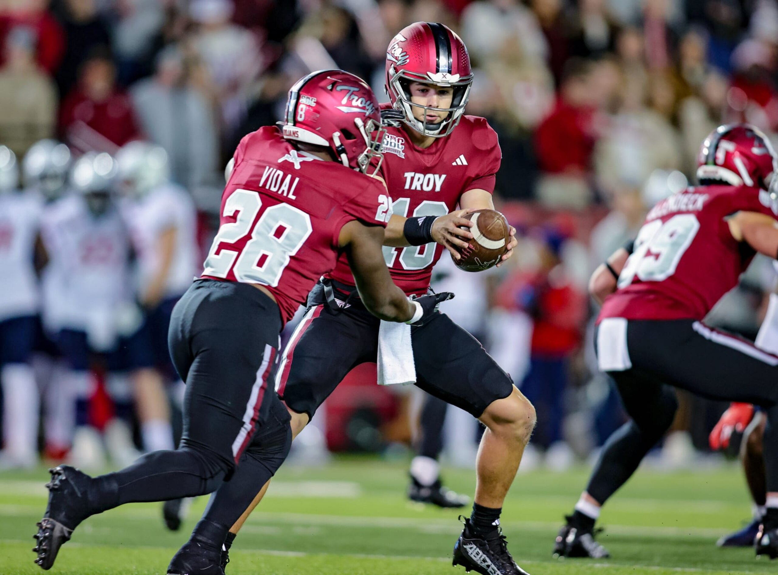 TROY, ALABAMA - NOVEMBER 2: Gunnar Watson #18 hands the ball off to Kimani Vidal #28 of the Troy Trojans during the first half at Veterans Memorial Stadium on November 2, 2023 in Troy, Alabama. (Photo by Brandon Sumrall/Getty Images)