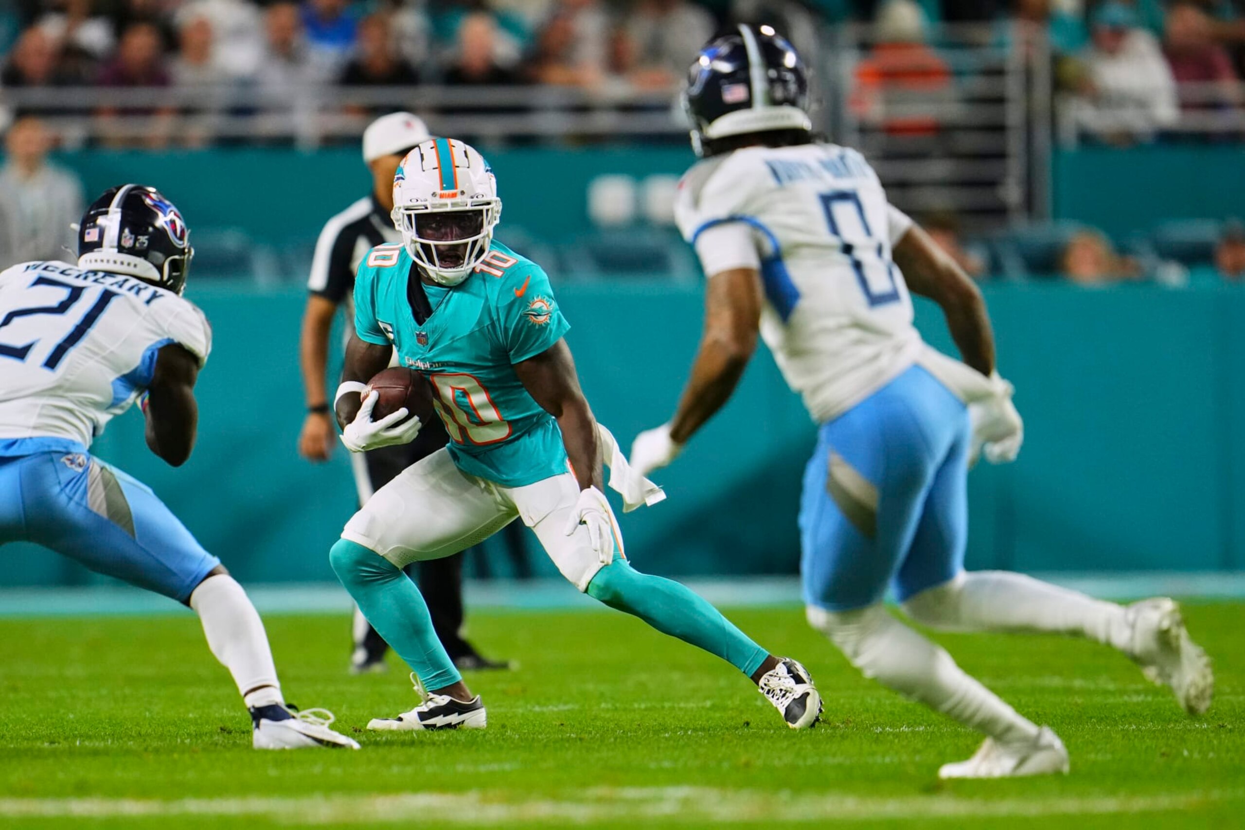 MIAMI GARDENS, FL - DECEMBER 11: Tyreek Hill #10 of the Miami Dolphins carries the ball against the Tennessee Titans during the first half at Hard Rock Stadium on December 11, 2023 in Miami Gardens, Florida. (Photo by Cooper Neill/Getty Images)