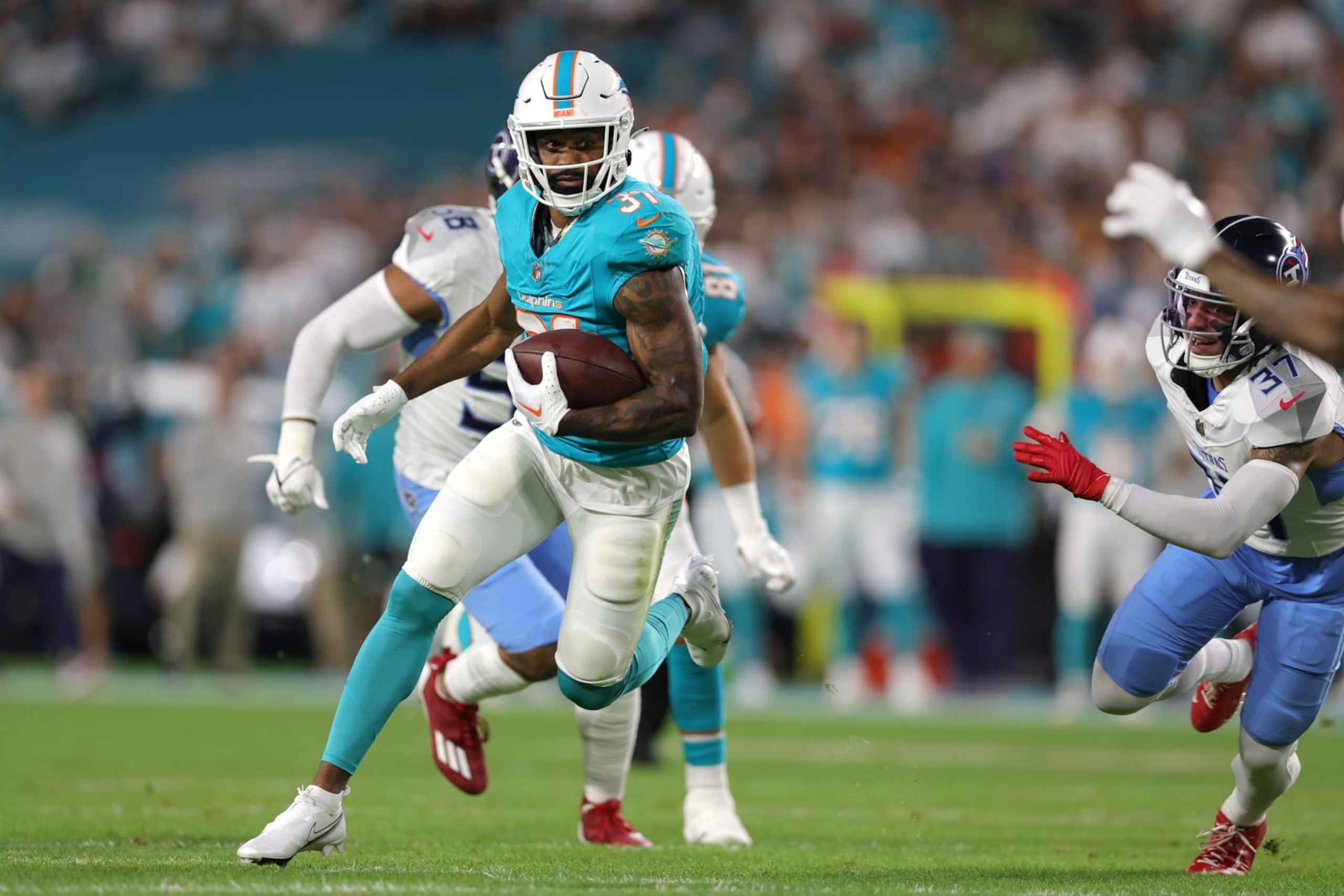 MIAMI GARDENS, FLORIDA - DECEMBER 11: Raheem Mostert #31 of the Miami Dolphins runs the ball in the first quarter against the Tennessee Titans at Hard Rock Stadium on December 11, 2023 in Miami Gardens, Florida. (Photo by Megan Briggs/Getty Images)