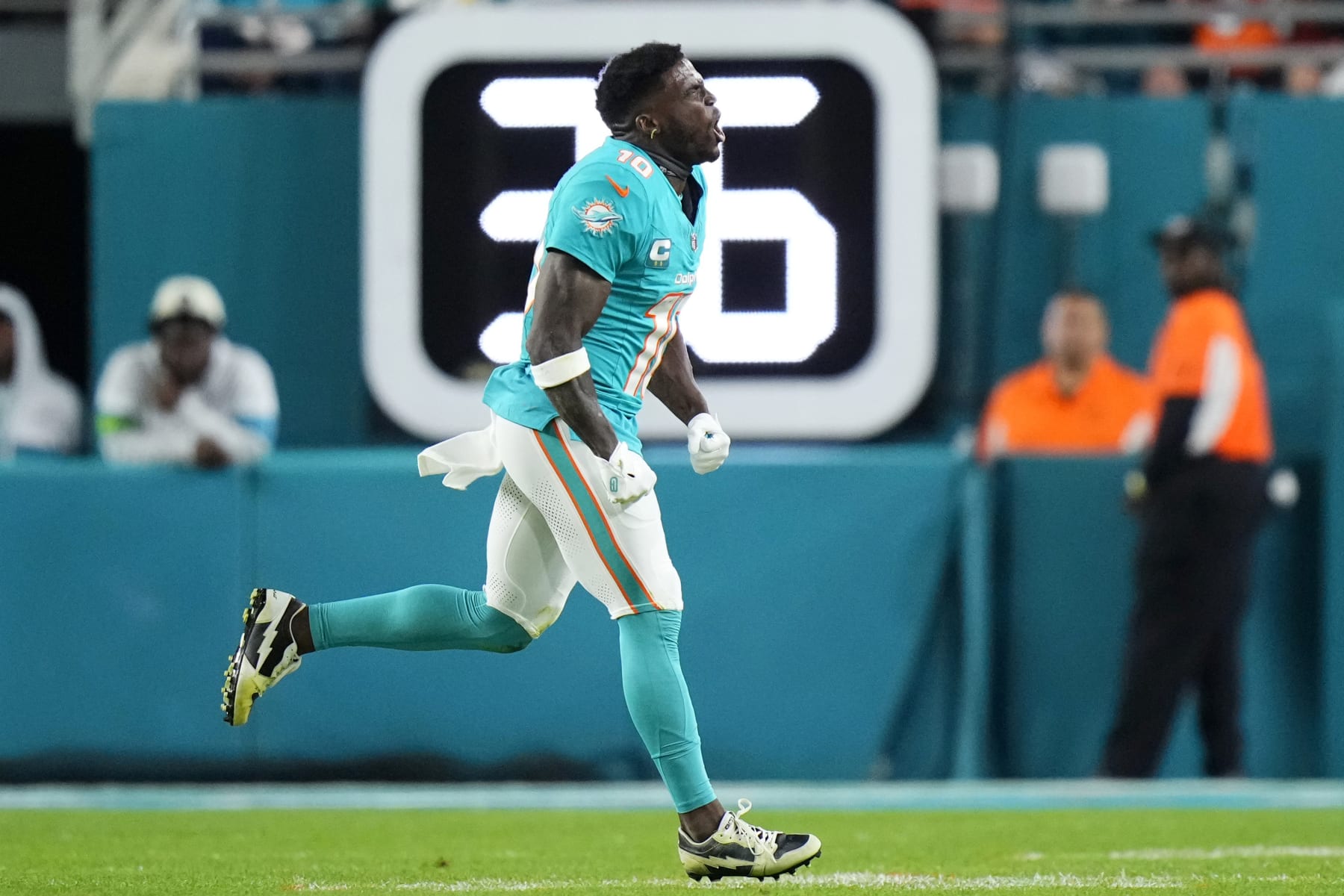MIAMI GARDENS, FLORIDA - DECEMBER 11: Tyreek Hill #10 of the Miami Dolphins runs to the sidelines in the first half at Hard Rock Stadium on December 11, 2023 in Miami Gardens, Florida. (Photo by Rich Storry/Getty Images)