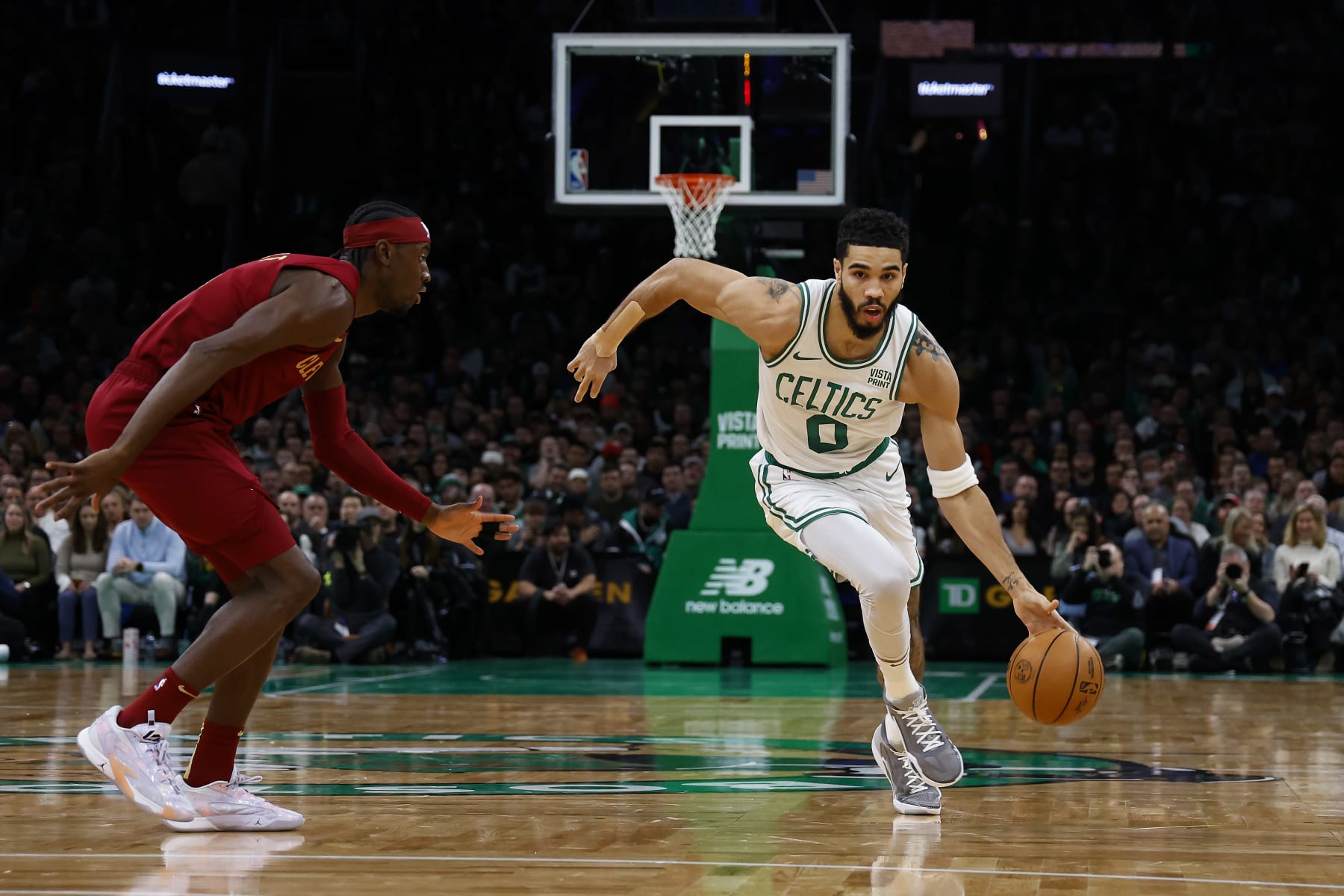 BOSTON, MA - DECEMBER 12: Jayson Tatum #0 of the Boston Celtics drives past Caris LeVert #3 of the Cleveland Cavaliers during the first quarter at TD Garden on December 12, 2023 in Boston, Massachusetts. NOTE TO USER: User expressly acknowledges and agrees that, by downloading and/or using this Photograph, user is consenting to the terms and conditions of the Getty Images License Agreement. (Photo By Winslow Townson/Getty Images)