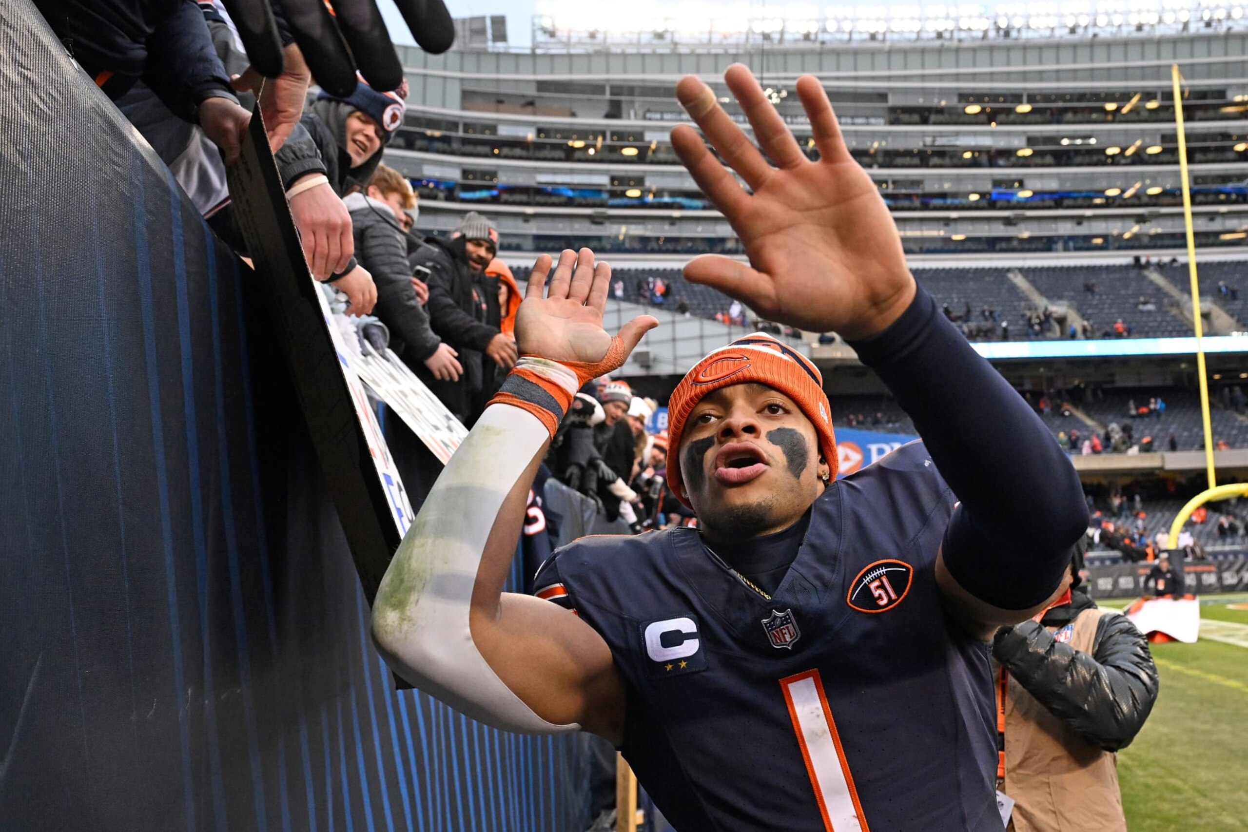 CHICAGO, ILLINOIS - DECEMBER 10: Justin Fields #1 of the Chicago Bears interacts with fans after a win over the Detroit Lions at Soldier Field on December 10, 2023 in Chicago, Illinois. (Photo by Quinn Harris/Getty Images)