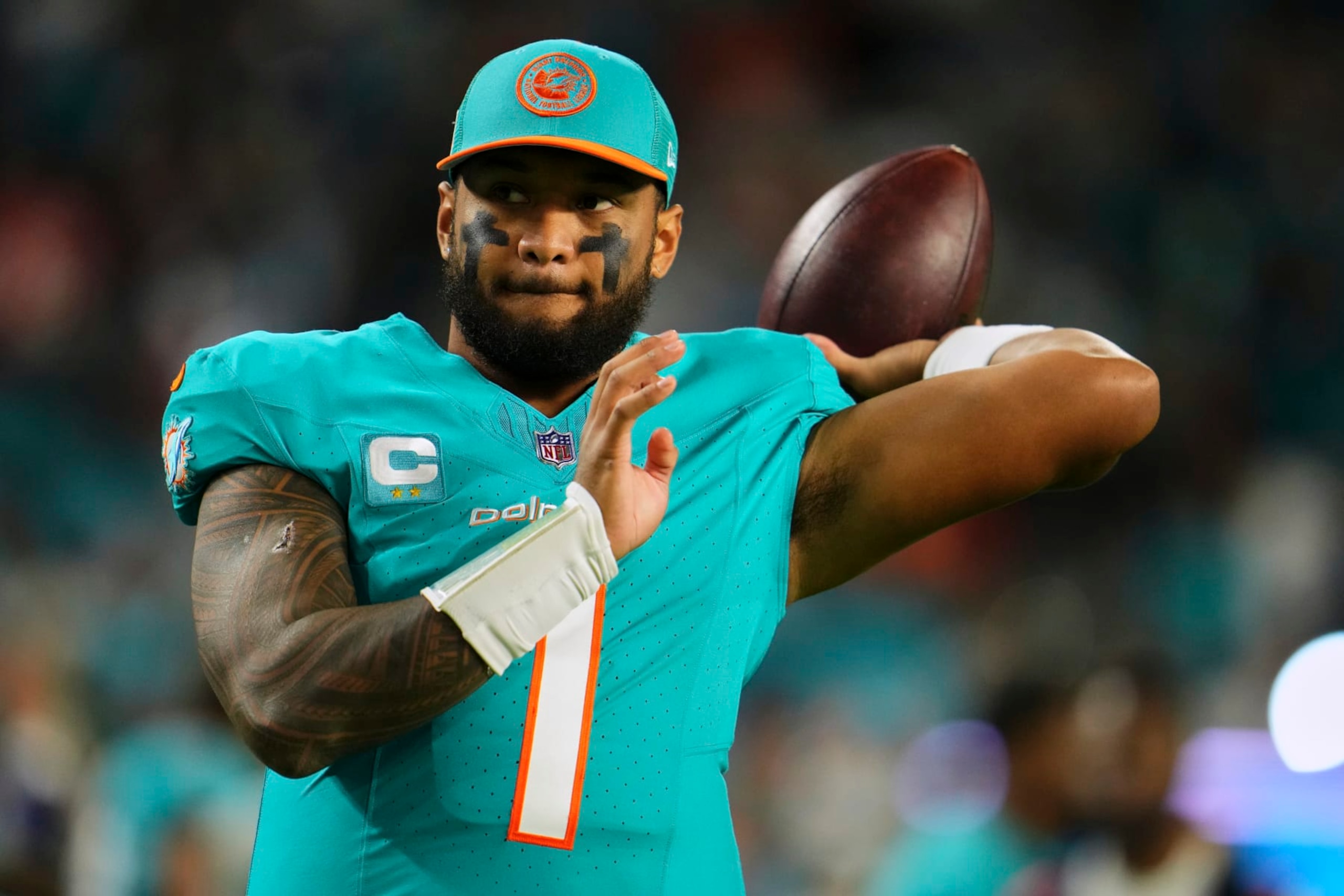 MIAMI GARDENS, FL - DECEMBER 11: Tua Tagovailoa #1 of the Miami Dolphins warms up before kickoff against the Tennessee Titans at Hard Rock Stadium on December 11, 2023 in Miami Gardens, Florida. (Photo by Cooper Neill/Getty Images)