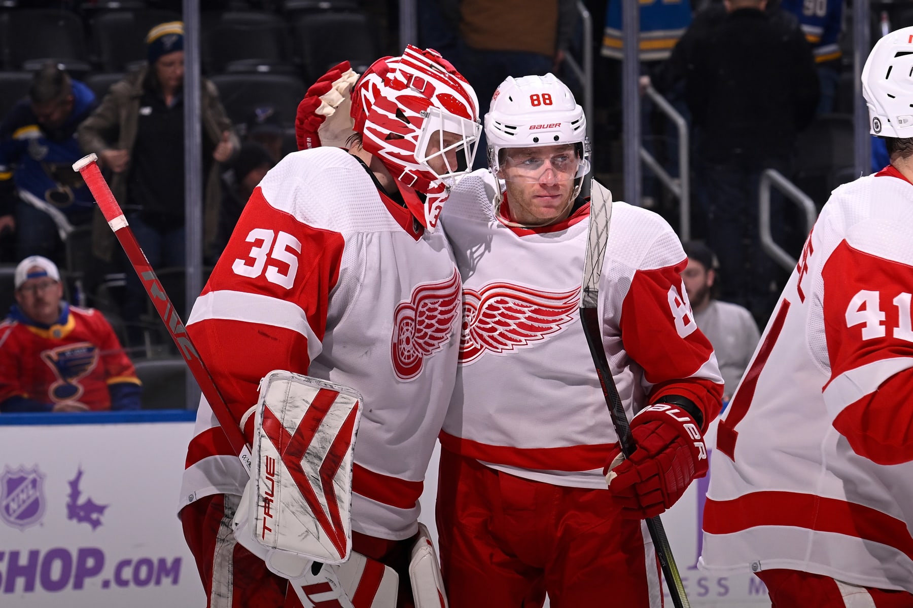 ST. LOUIS, MO - DECEMBER 12: Ville Husso #35 and Patrick Kane #88 of the Detroit Red Wings celebrate their team's 6-4 victory over the St. Louis Blues on December 12, 2023 at the Enterprise Center in St. Louis, Missouri. (Photo by Joe Puetz/NHLI via Getty Images)