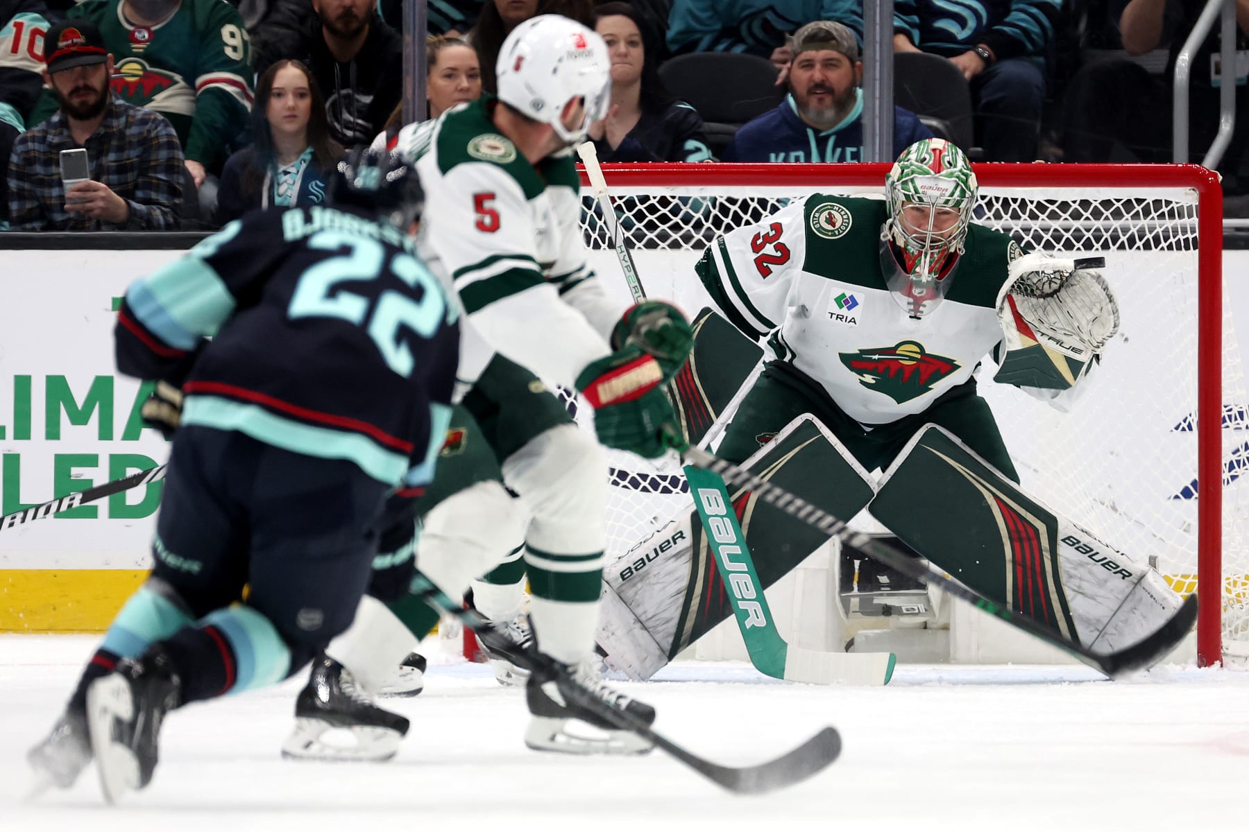 SEATTLE, WASHINGTON - DECEMBER 10: Filip Gustavsson #32 of the Minnesota Wild makes a save against Oliver Bjorkstrand #22 of the Seattle Kraken during the first period at Climate Pledge Arena on December 10, 2023 in Seattle, Washington. (Photo by Steph Chambers/Getty Images)