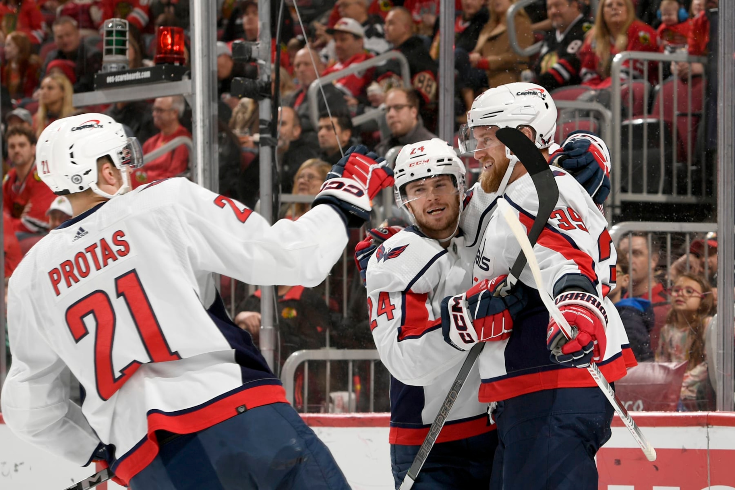 CHICAGO, ILLINOIS - DECEMBER 10: Connor McMichael #24 of the Washington Capitals hugs Anthony Mantha #39 of the Washington Capitals after Mantha scores against the Chicago Blackhawks at the United Center on December 10, 2023 in Chicago, Illinois. (Photo by Bill Smith/NHLI via Getty Images)