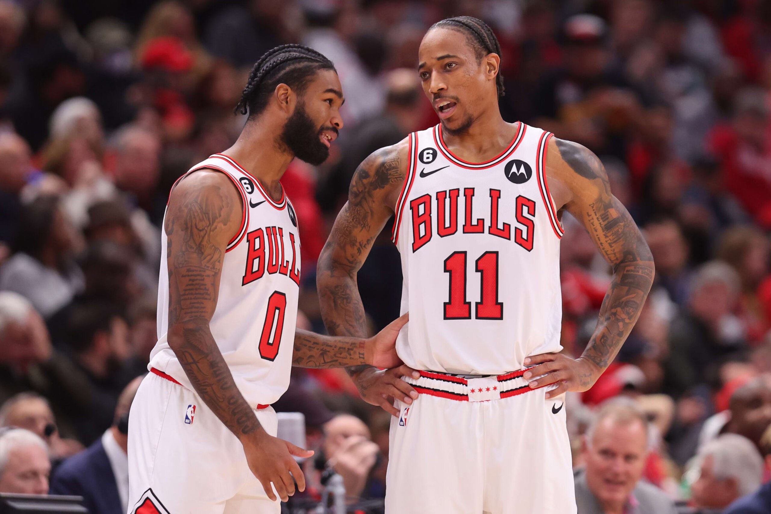 CHICAGO, ILLINOIS - DECEMBER 07: Coby White #0 and DeMar DeRozan #11 of the Chicago Bulls converse against the Washington Wizards during the second half at United Center on December 07, 2022 in Chicago, Illinois. NOTE TO USER: User expressly acknowledges and agrees that, by downloading and or using this photograph, User is consenting to the terms and conditions of the Getty Images License Agreement.  (Photo by Michael Reaves/Getty Images)