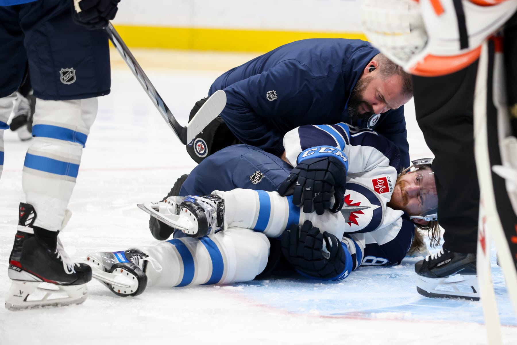 ANAHEIM, CA - DECEMBER 10:  Kyle Connor #81 of the Winnipeg Jets falls to the ground after an apparent injury during the second period against the Anaheim Ducks at Honda Center on December 10, 2023 in Anaheim, California. (Photo by Debora Robinson/NHLI via Getty Images)