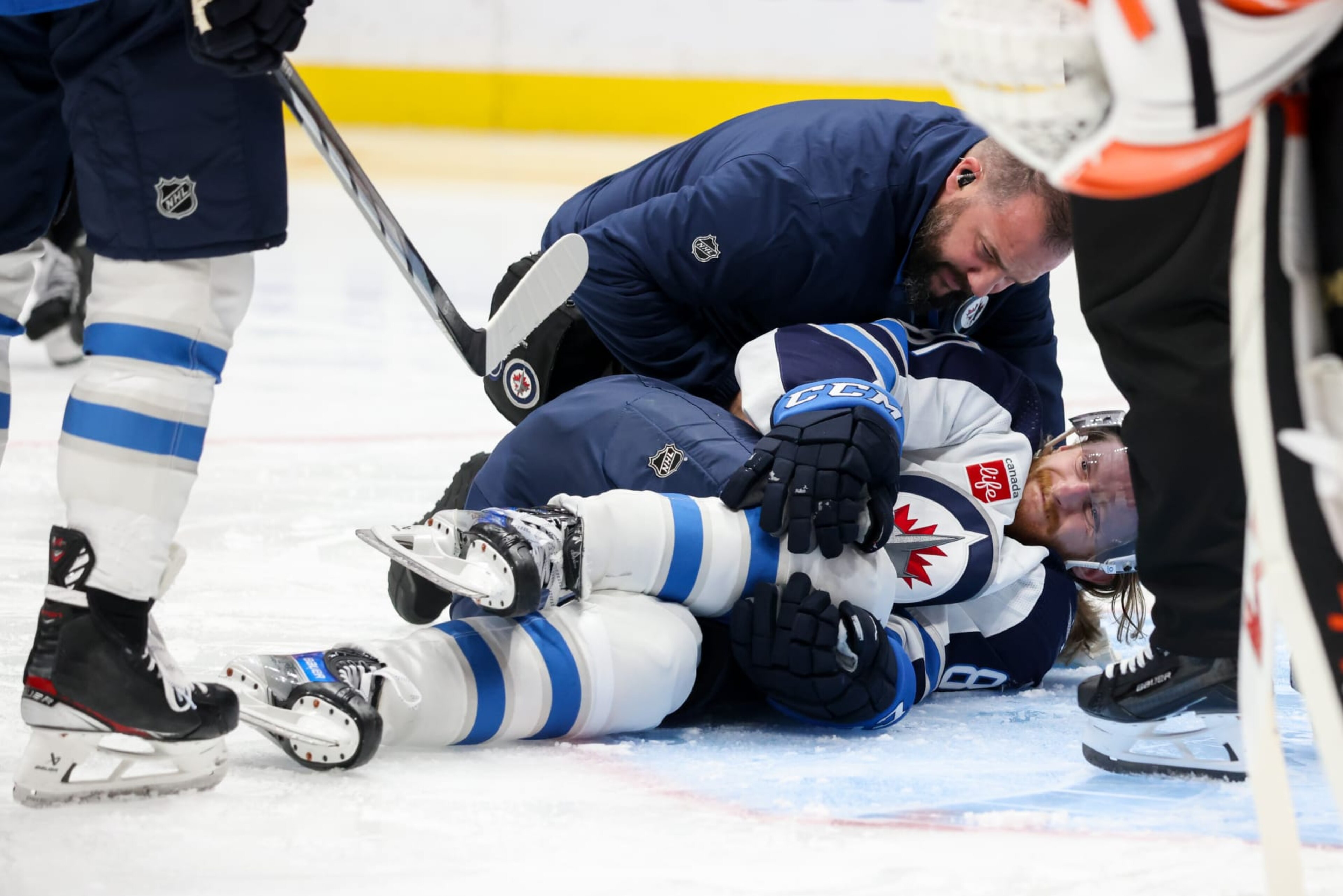 ANAHEIM, CA - DECEMBER 10: Kyle Connor #81 of the Winnipeg Jets falls to the ground after an apparent injury during the second period against the Anaheim Ducks at Honda Center on December 10, 2023 in Anaheim, California. (Photo by Debora Robinson/NHLI via Getty Images) ANAHEIM, CA - DECEMBER 10: Kyle Connor #81 of the Winnipeg Jets falls to the ground after an apparent injury during the second period against the Anaheim Ducks at Honda Center on December 10, 2023 in Anaheim, California. (Photo by Debora Robinson/NHLI via Getty Images)