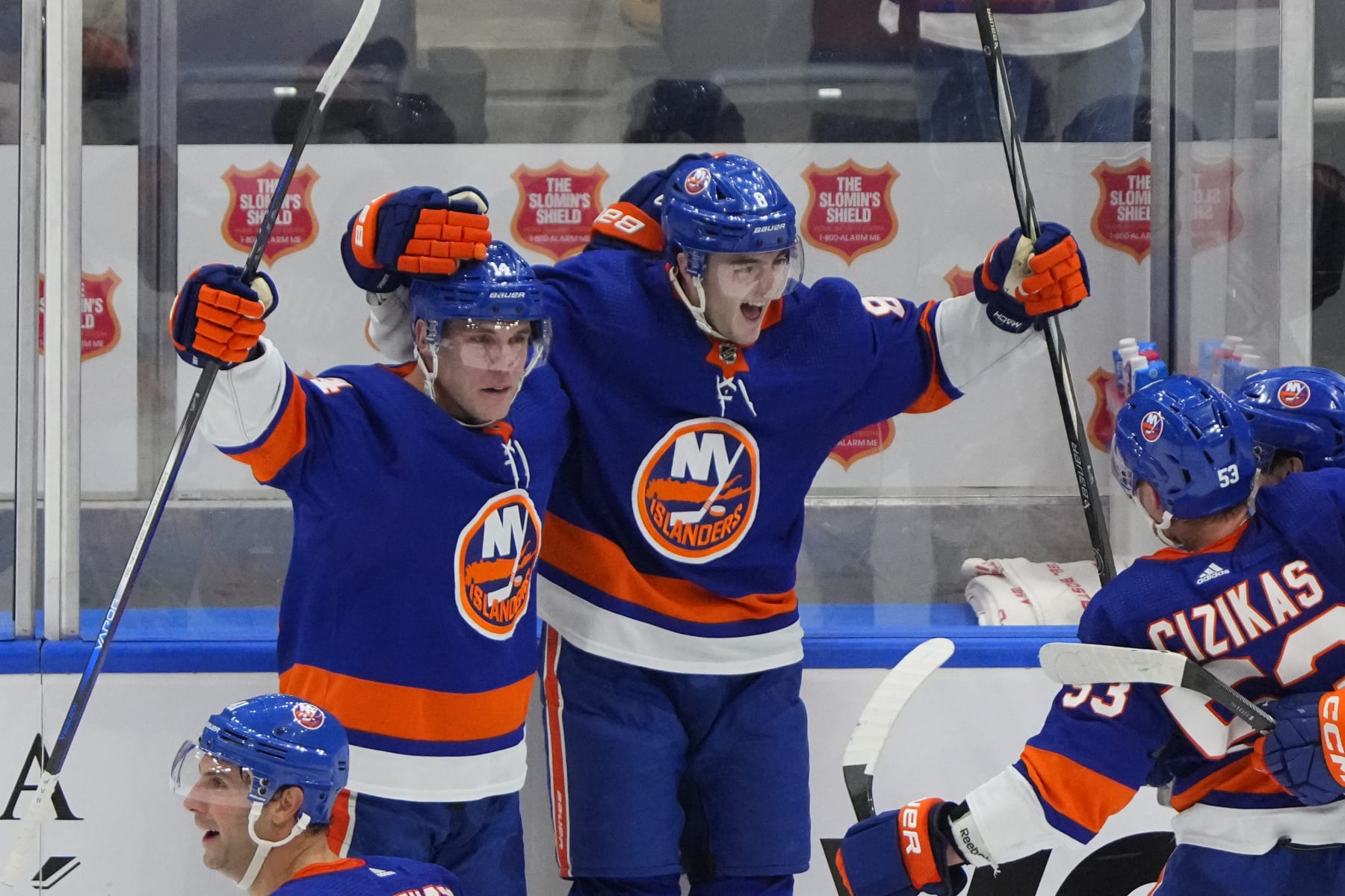 ELMONT, NY - DECEMBER 11: New York Islanders Defenseman Noah Dobson (8) celebrates New York Islanders Center Bo Horvat (14) winning goal with him during the overtime period of the National Hockey League game between the Toronto Maple Leafs and the New York Islanders on December 11, 2023, at UBS Arena in Elmont, NY. (Photo by Gregory Fisher/Icon Sportswire via Getty Images)
