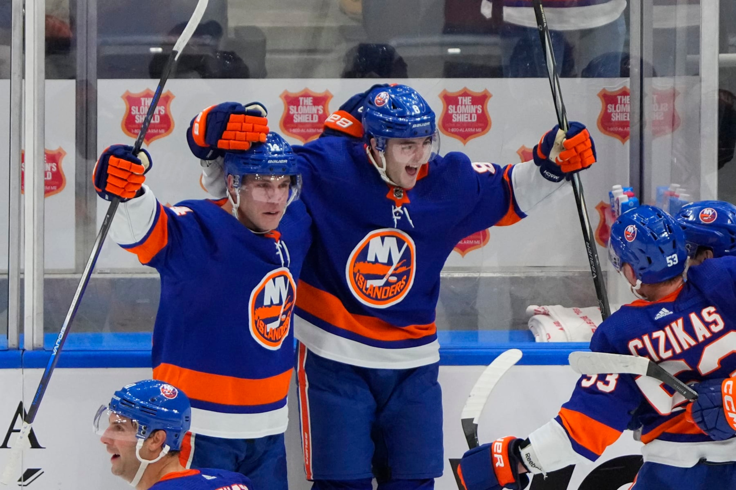 ELMONT, NY - DECEMBER 11: New York Islanders Defenseman Noah Dobson (8) celebrates New York Islanders Center Bo Horvat (14) winning goal with him during the overtime period of the National Hockey League game between the Toronto Maple Leafs and the New York Islanders on December 11, 2023, at UBS Arena in Elmont, NY. (Photo by Gregory Fisher/Icon Sportswire via Getty Images)