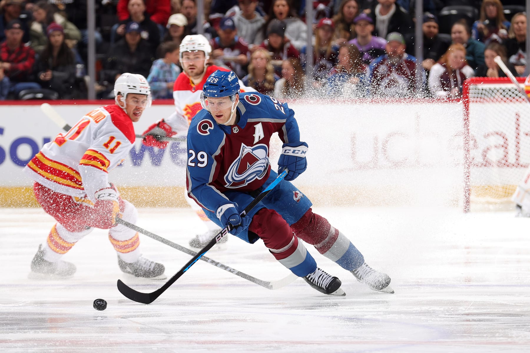 DENVER, COLORADO - DECEMBER 11: Nathan MacKinnon #29 of the Colorado Avalanche skates against Mikael Backlund #11 of the Calgary Flames at Ball Arena on December 11, 2023 in Denver, Colorado.  (Photo by Michael Martin/NHLI via Getty Images)