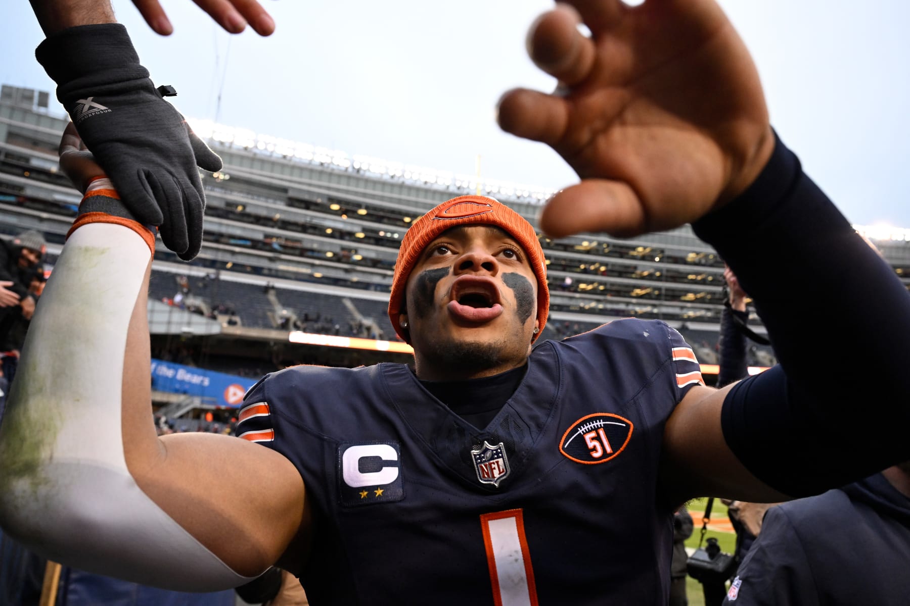 CHICAGO, ILLINOIS - DECEMBER 10: Justin Fields #1 of the Chicago Bears interacts with fans after a win over the Detroit Lions at Soldier Field on December 10, 2023 in Chicago, Illinois. (Photo by Quinn Harris/Getty Images)