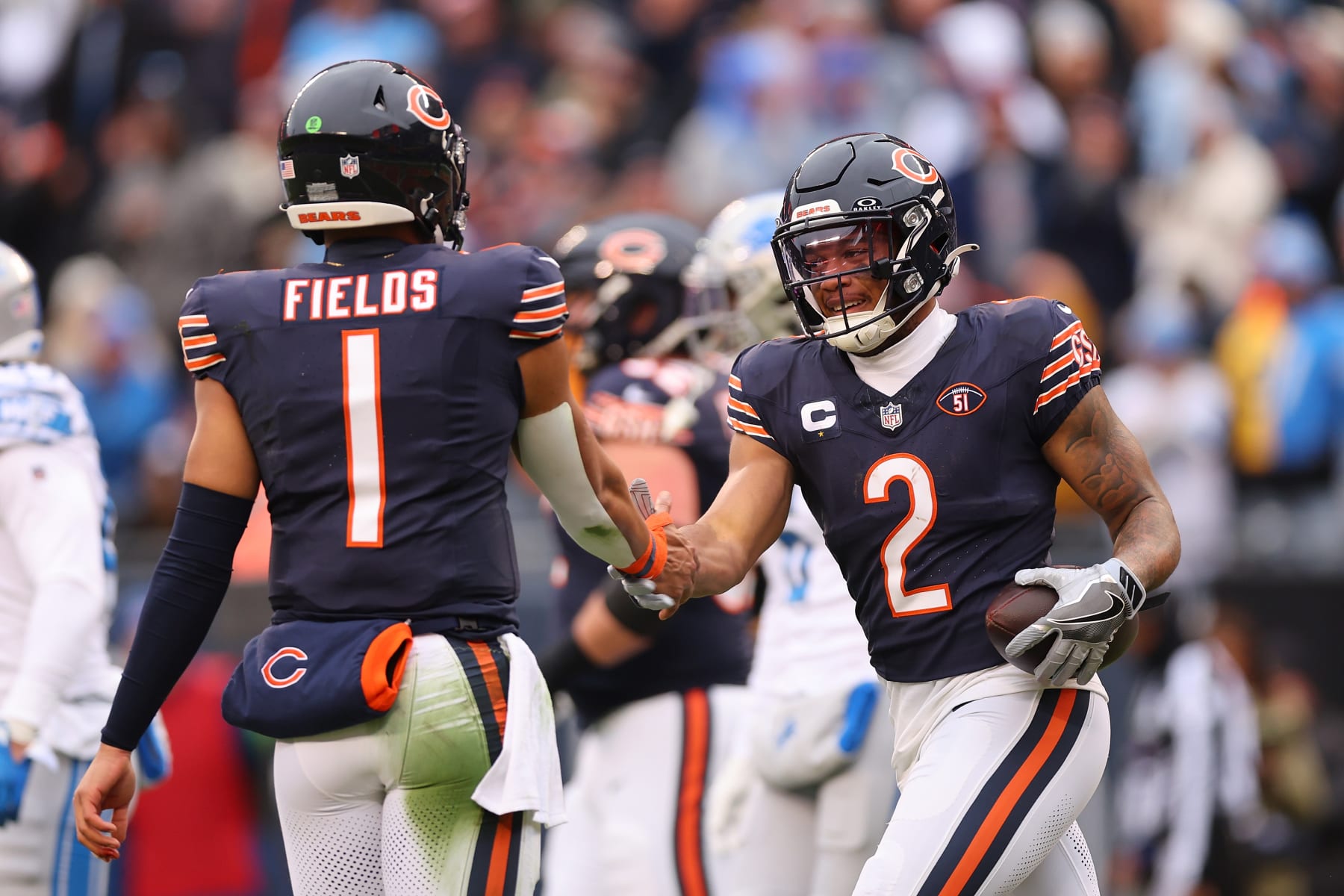 CHICAGO, ILLINOIS - DECEMBER 10: DJ Moore #2 of the Chicago Bears celebrates after a touchdown with Justin Fields #1 during the first quarter in the game against the Detroit Lions at Soldier Field on December 10, 2023 in Chicago, Illinois. (Photo by Michael Reaves/Getty Images)