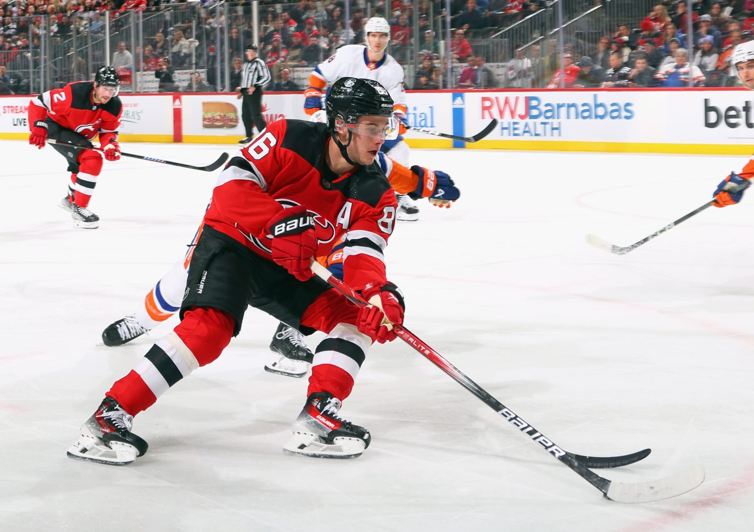 NEWARK, NEW JERSEY - NOVEMBER 28: Jack Hughes #86 of the New Jersey Devils skates against the New York Islanders at Prudential Center on November 28, 2023 in Newark, New Jersey. (Photo by Bruce Bennett/Getty Images)