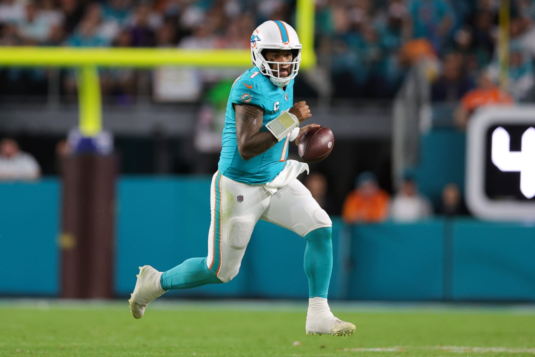 MIAMI GARDENS, FLORIDA - DECEMBER 11: Tua Tagovailoa #1 of the Miami Dolphins carries the ball against the Tennessee Titans during the second quarter of the game at Hard Rock Stadium on December 11, 2023 in Miami Gardens, Florida. (Photo by Megan Briggs/Getty Images)