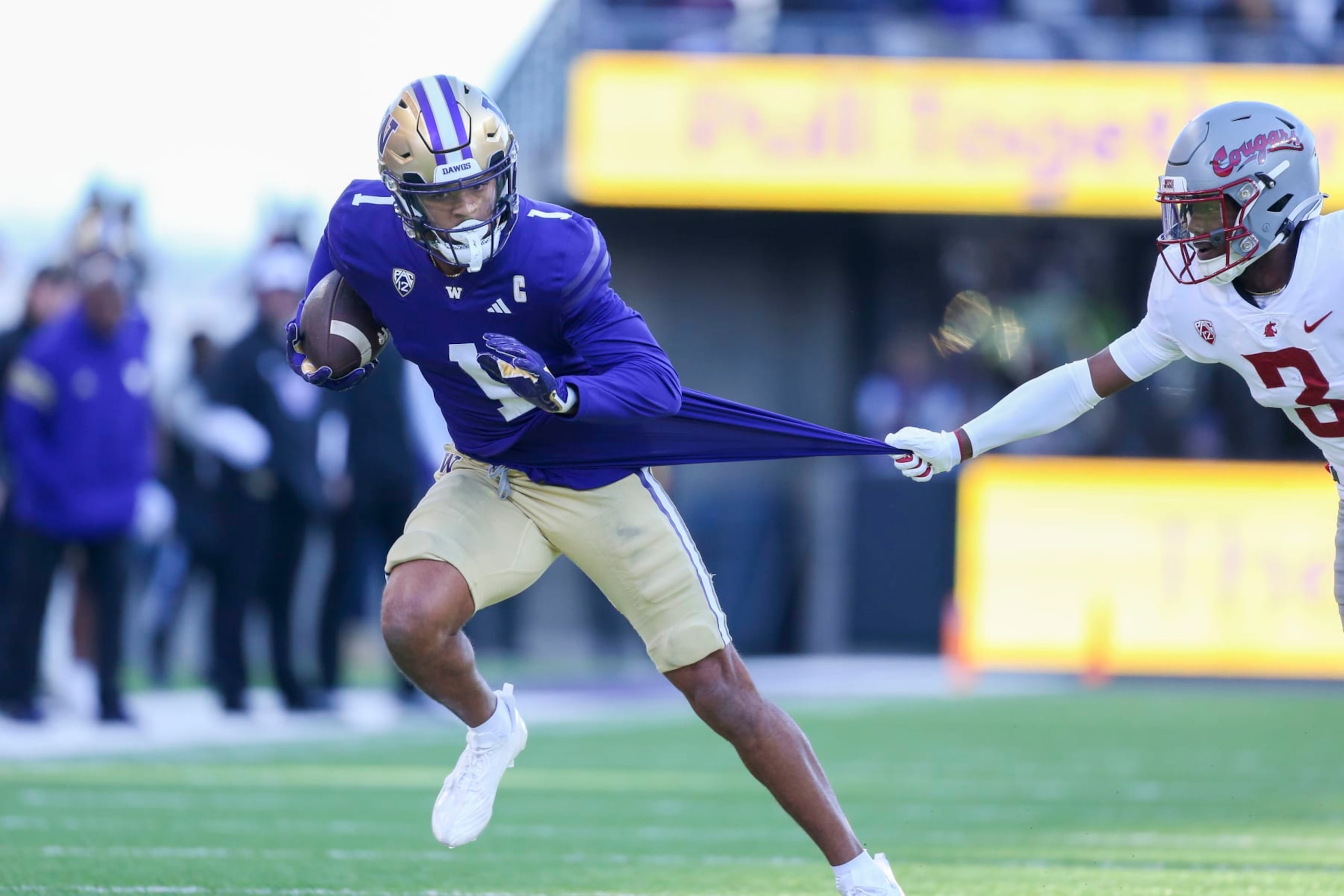 SEATTLE, WA - November 25:  Washington #1 (WR) Rome Odunze breaks up field as Washington State #3 (DB) Cam Lampkin hangs onto his jersey during the 115 Apple Cup college football game between the Washington Huskies and the Washington State Cougars on November 25, 2023, at Husky Stadium in Seattle, WA. (Photo by Jesse Beals/Icon Sportswire via Getty Images)