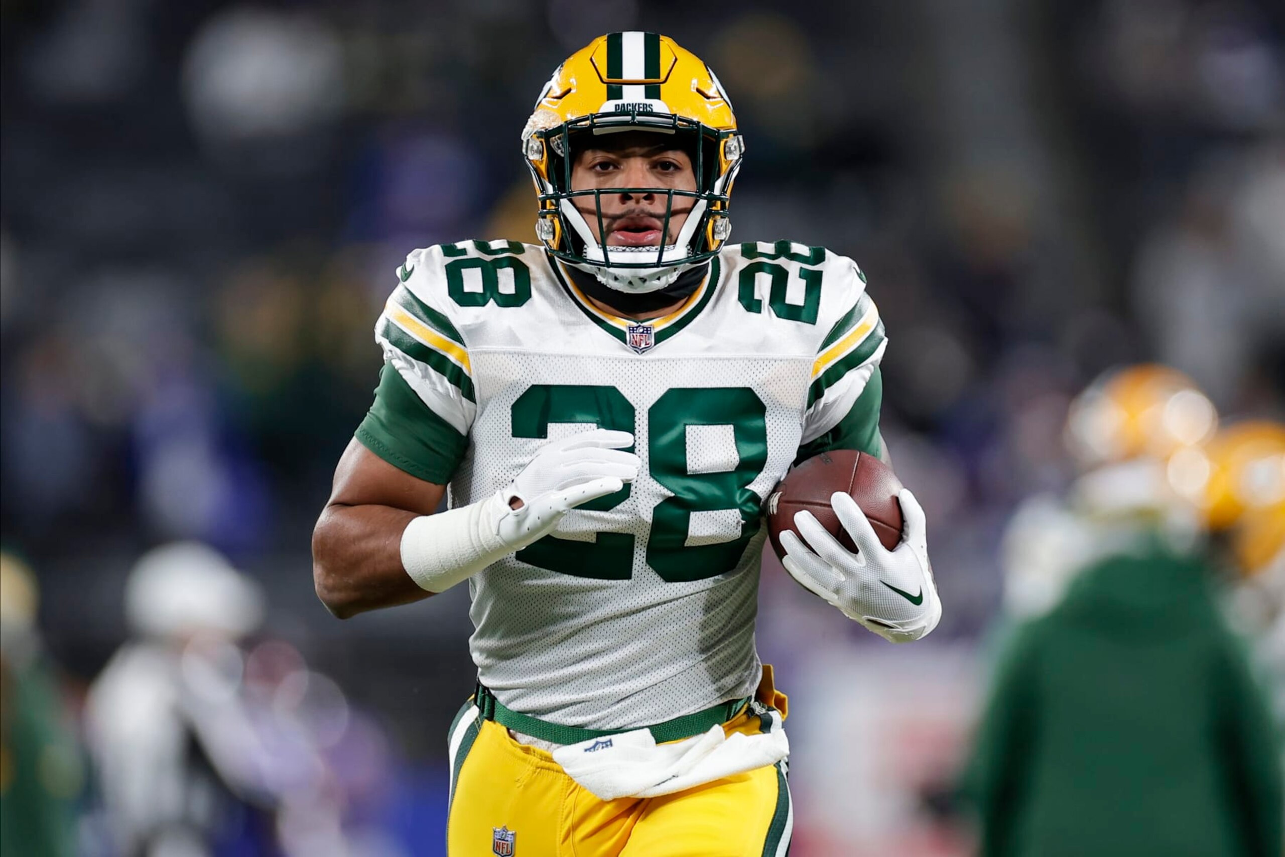Green Bay Packers running back AJ Dillon (28) warms up before playing against the New York Giants in an NFL football game, Monday, Dec. 11, 2023, in East Rutherford, N.J. (AP Photo/Adam Hunger)