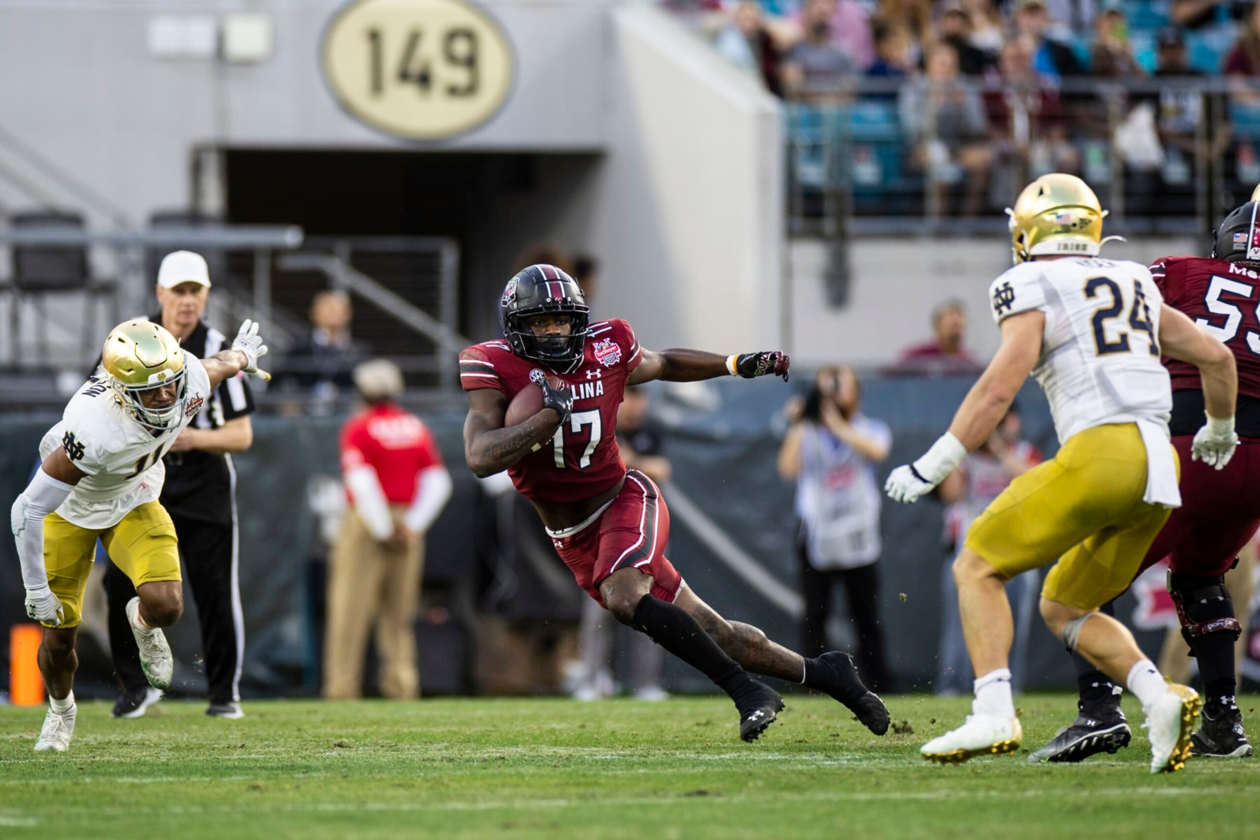 JACKSONVILLE, FLORIDA - DECEMBER 30: Xavier Legette #17 of the South Carolina Gamecocks runs the ball during the 2nd quarter of the TaxSlayer Gator Bowl against the Notre Dame Fighting Irish at TIAA Bank Field on December 30, 2022 in Jacksonville, Florida. (Photo by James Gilbert/Getty Images)