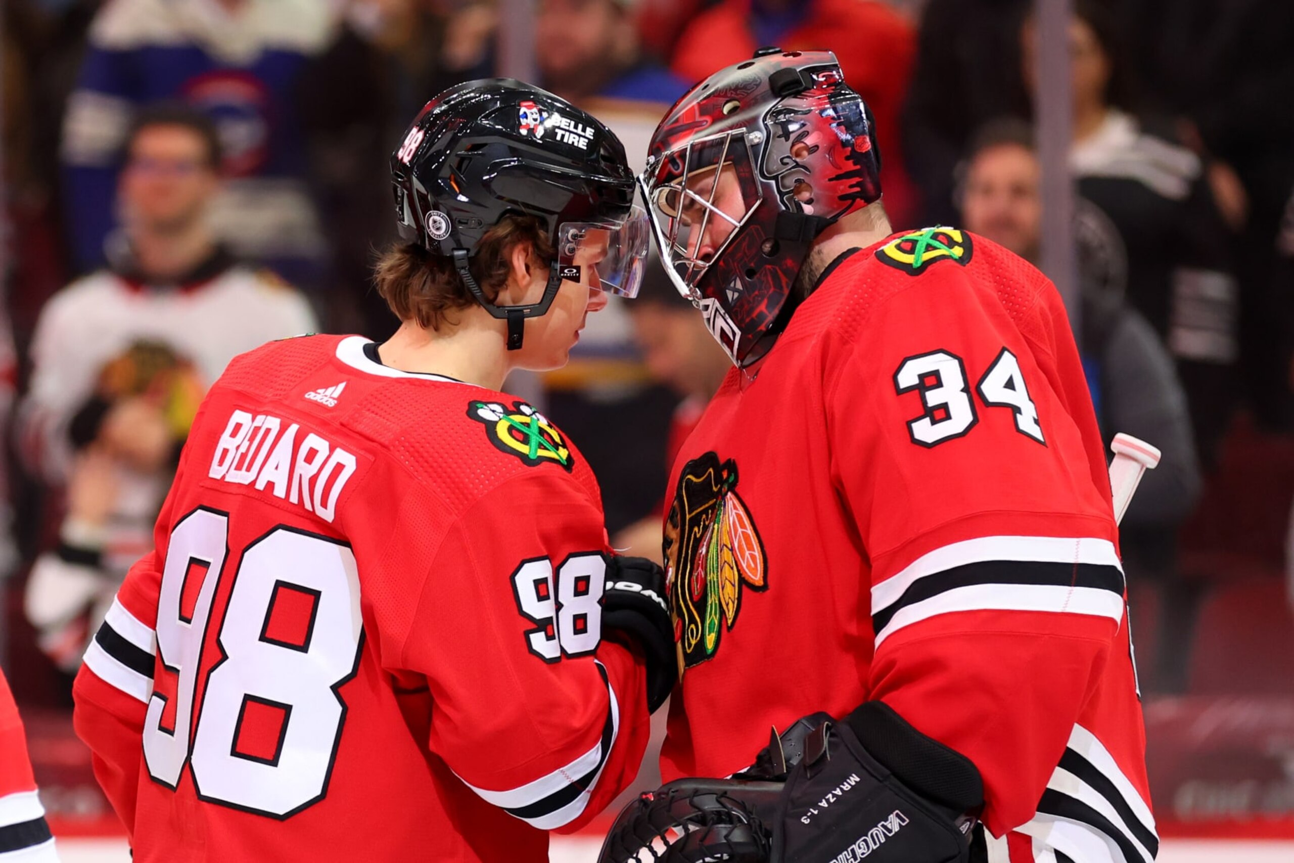 CHICAGO, ILLINOIS - DECEMBER 09: Connor Bedard #98 and Petr Mrazek #34 of the Chicago Blackhawks celebrate after defeating the St. Louis Blues 3-1 at the United Center on December 09, 2023 in Chicago, Illinois. (Photo by Michael Reaves/Getty Images)